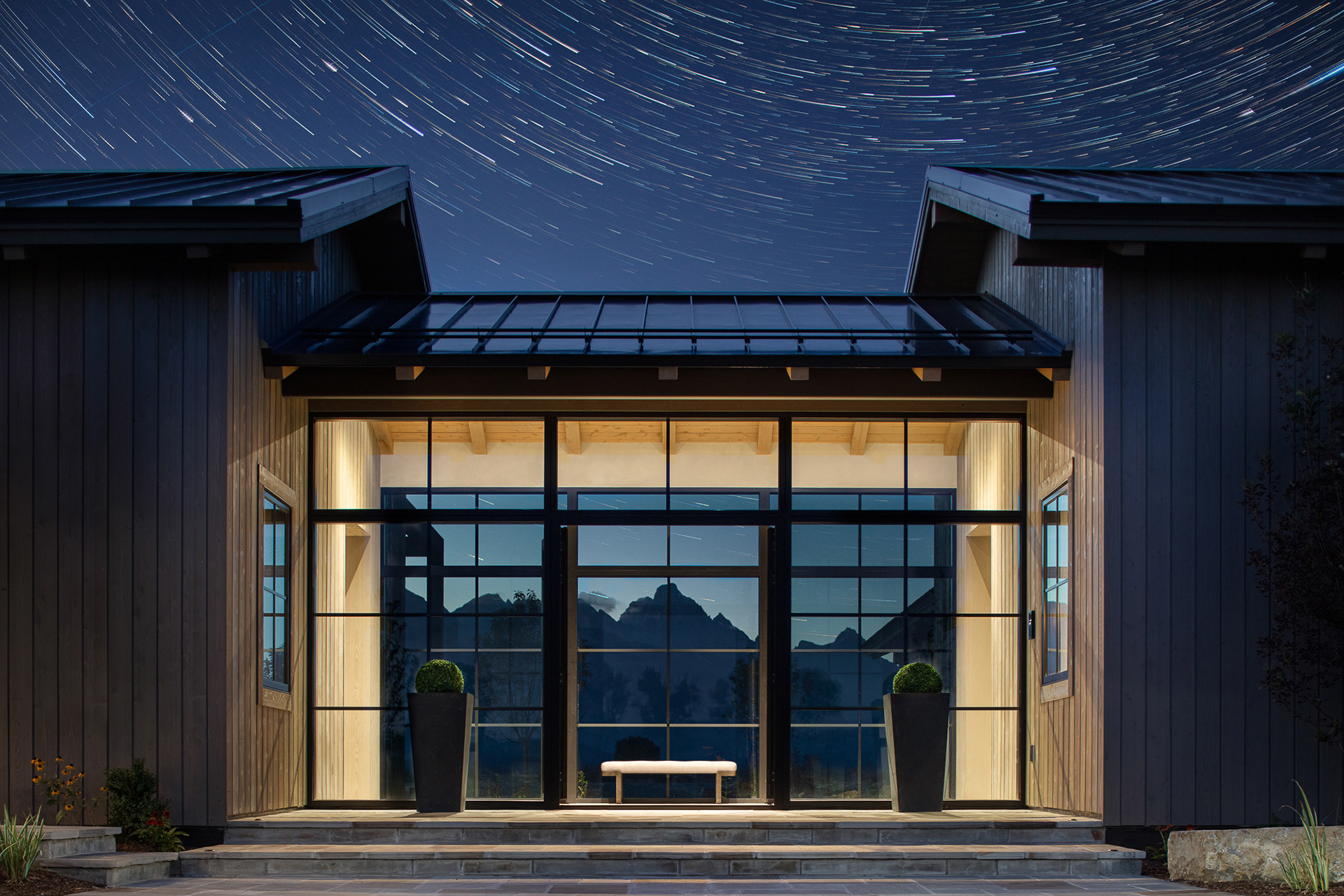 Starfall home in Jackson Hole Wyoming with star trails. Photography by architecture photographer Aaron Kraft Krafty Photos. Architectural design by Tyler Wilson Architects, building by Teton Heritage Builders with interior design by Nida Risto. Astrophotography