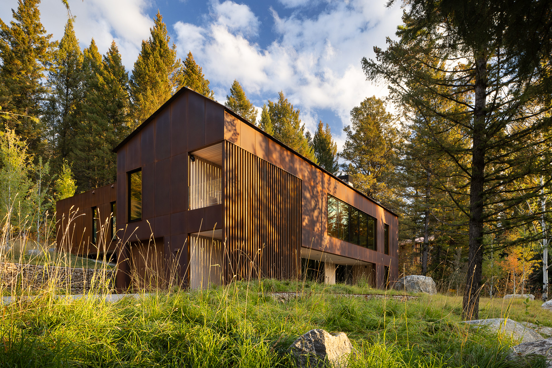 A modern home designed by clb architects in a fall setting in the forest. Photography by Aaron Kraft Krafty Photos