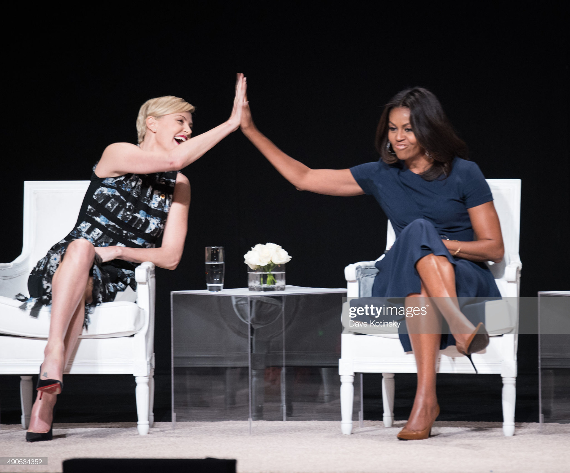 Founder of Charlize Theron Africa Outreach Project and U.N. Messenger of Peace Charlize Theron (L) and First Lady of the United States Michelle Obama join the "Let Girls Learn" Global Conversation at The Apollo Theater on September 29, 2015 in New York City. (Photo by Dave Kotinsky/Getty Images for Global Goals)