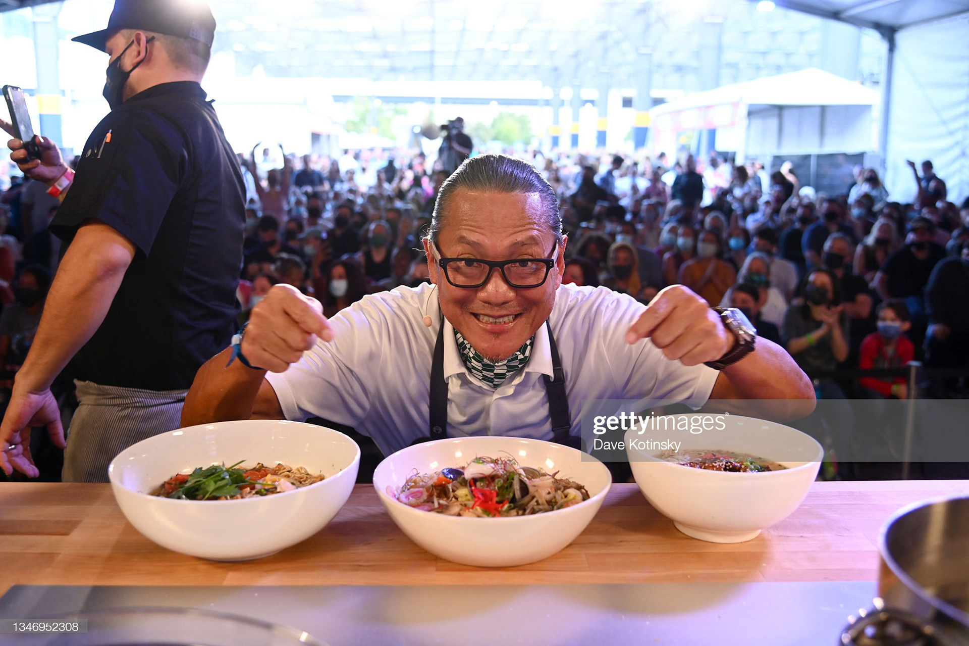 Chef Masaharu Morimoto poses with the food he created at his food demonstration during the Grand Tasting featuring culinary demonstrations presented by Liebherr Appliances during the Food Network & Cooking Channel New York City Wine & Food Festival presented by Capital One at Pier 76 on October 16, 2021 in New York City. (Photo by Dave Kotinsky/Getty Images for NYCWFF)