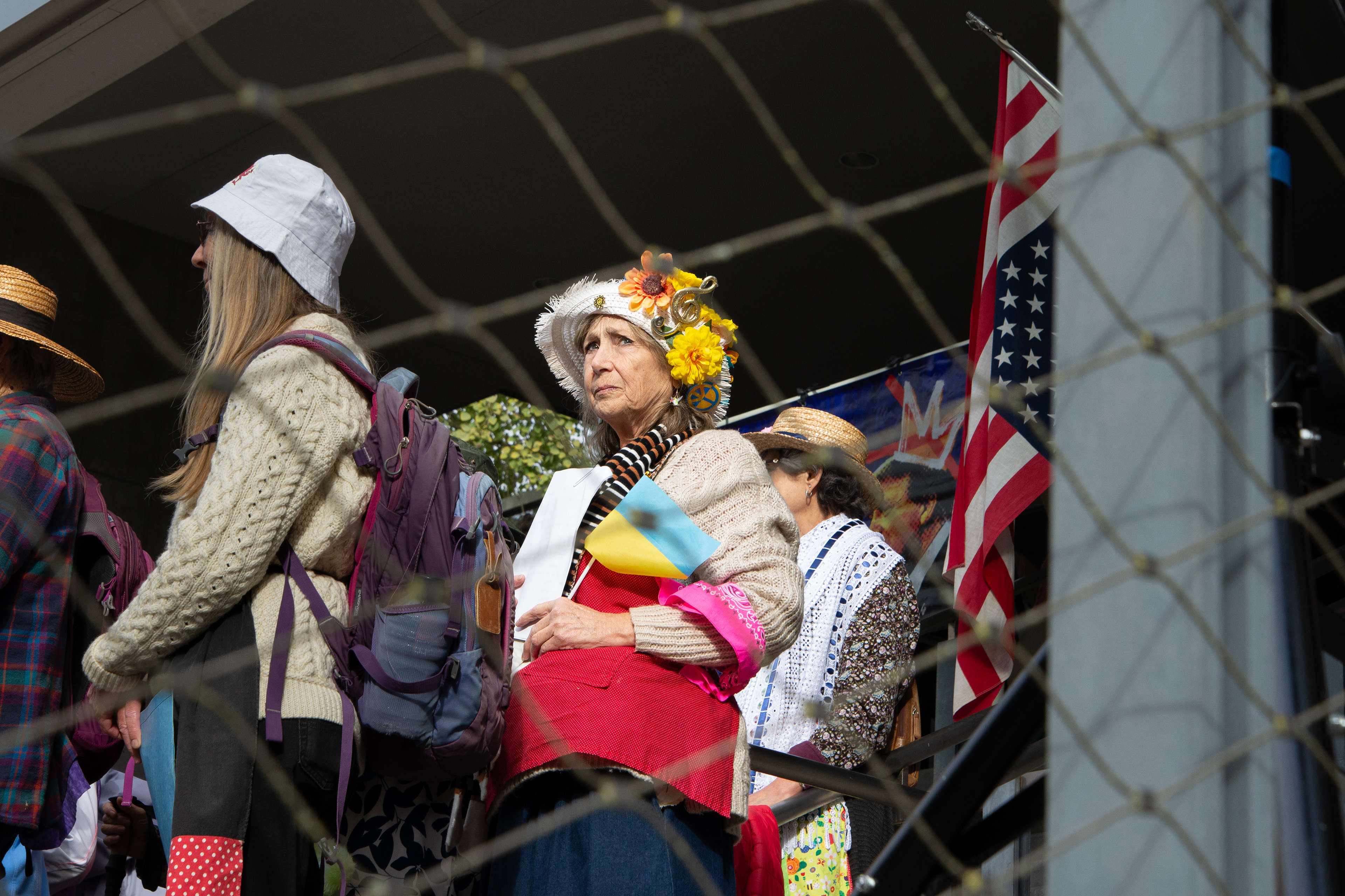 A woman looks out at a crowd of protesters attending the No Kings protest in Eugene, OR on October 18, 2025