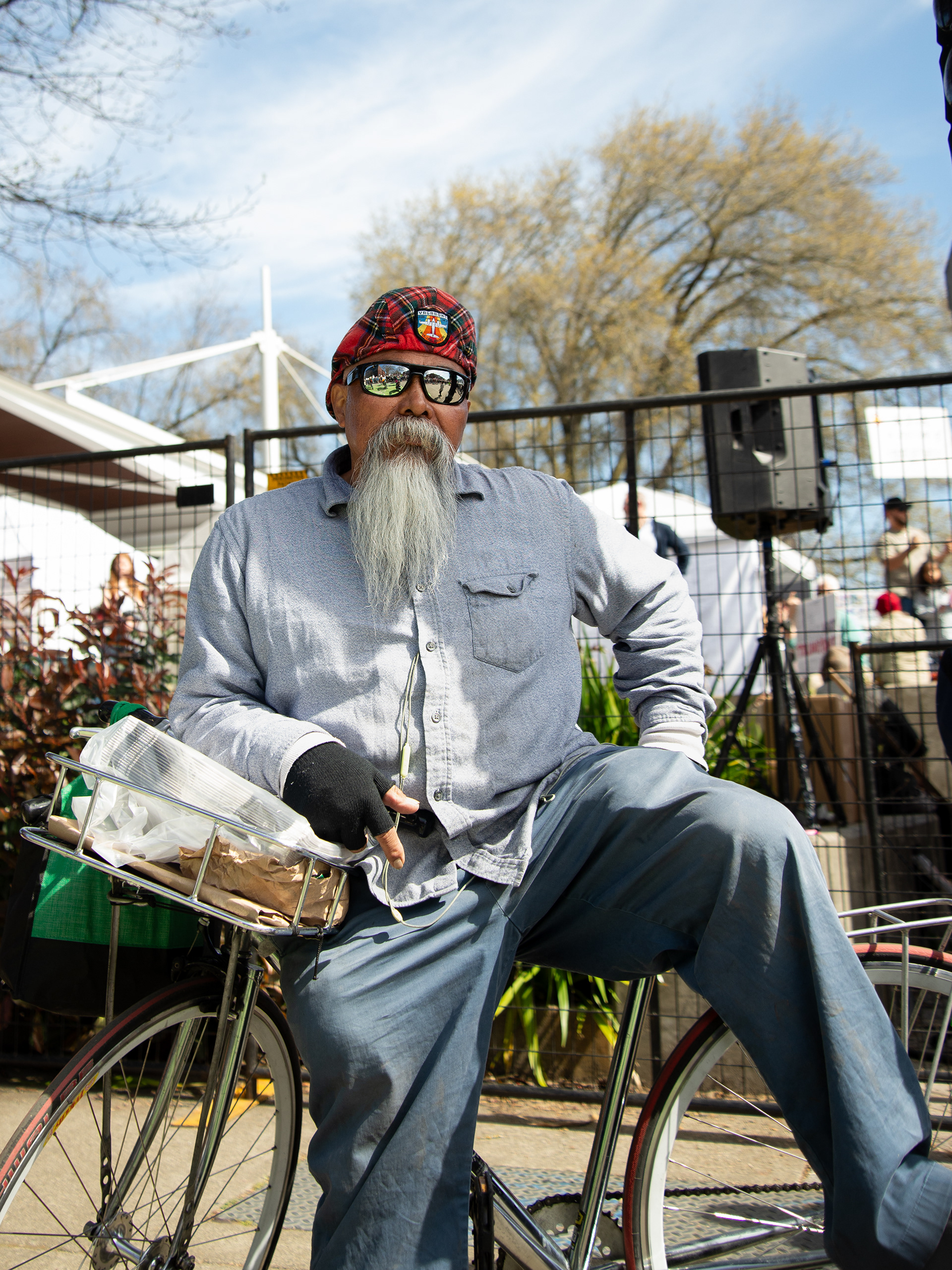 A man rests along the Portland waterfront during the No Kings Protest on March 28, 2026