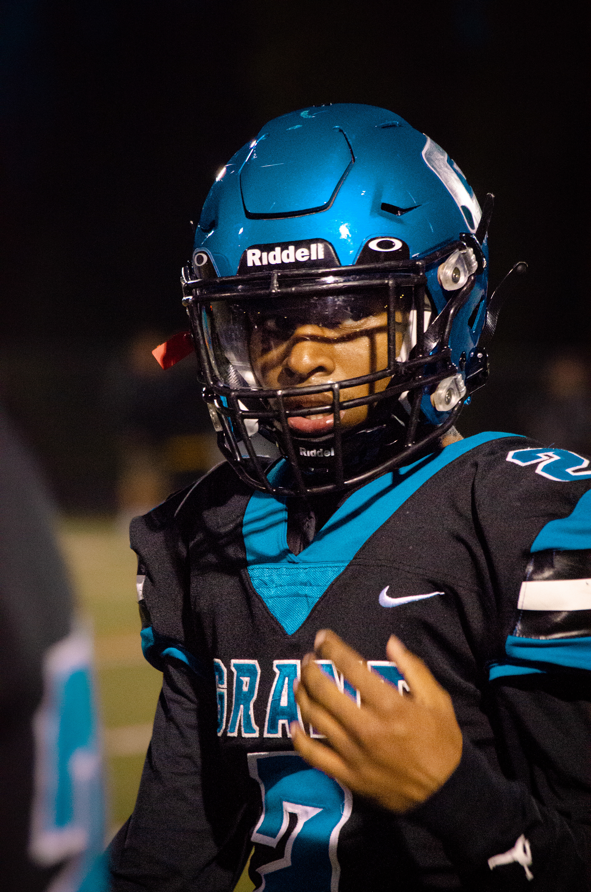 A football player listens to coaching before stepping onto the field