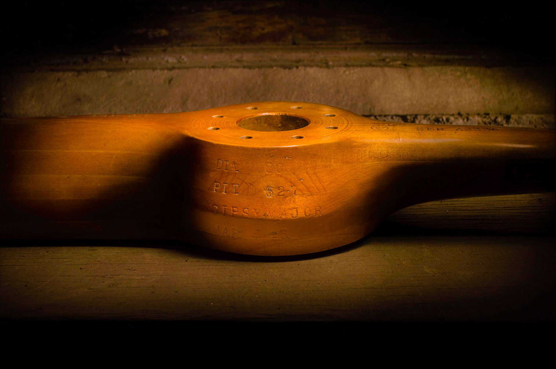An old wooden propeller on a workbench