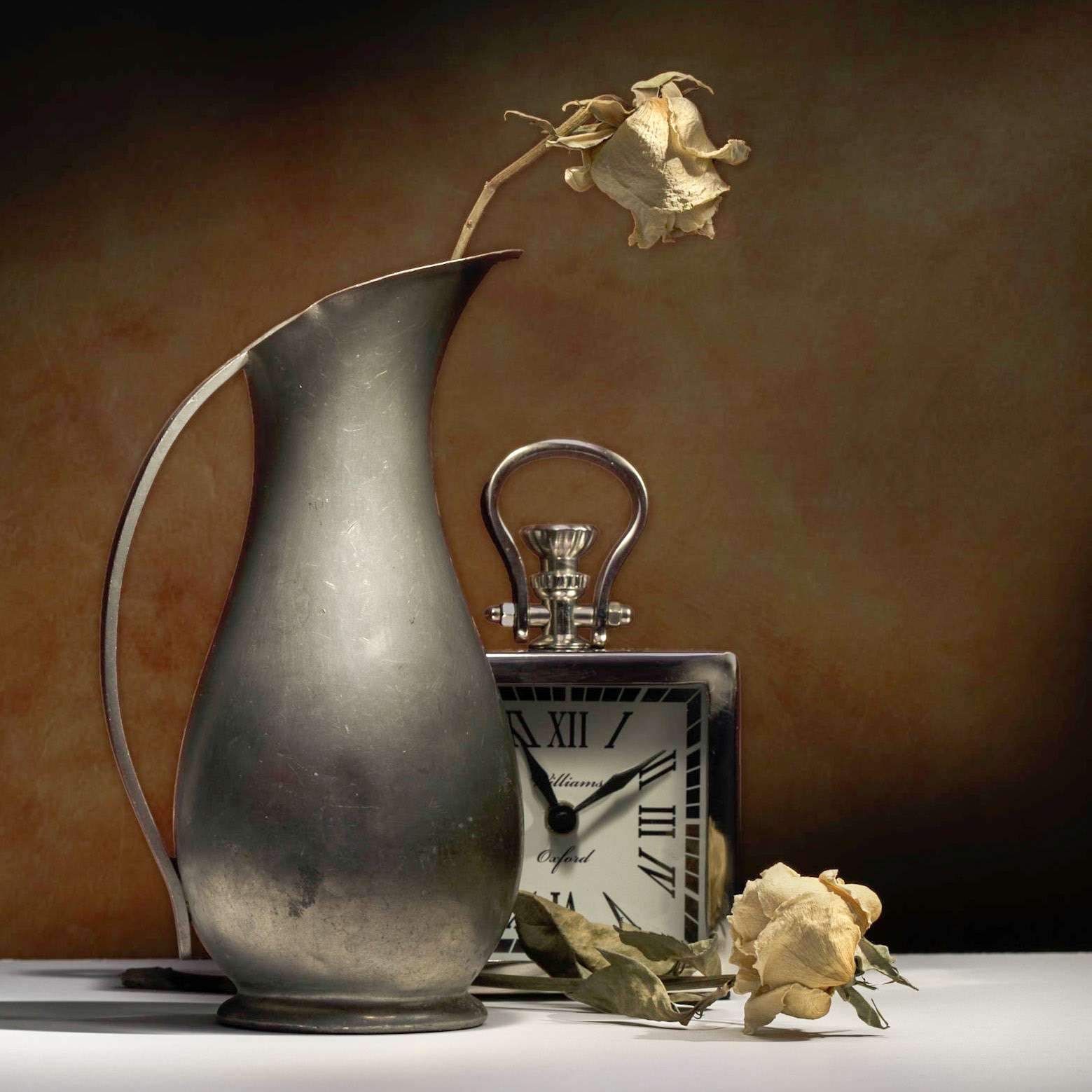 Lightpainting of a couple of dried roses in a pewter vase.  I kind of liked the idea of a clock with the dead roses.The roses seem to take on a new life in this still life.