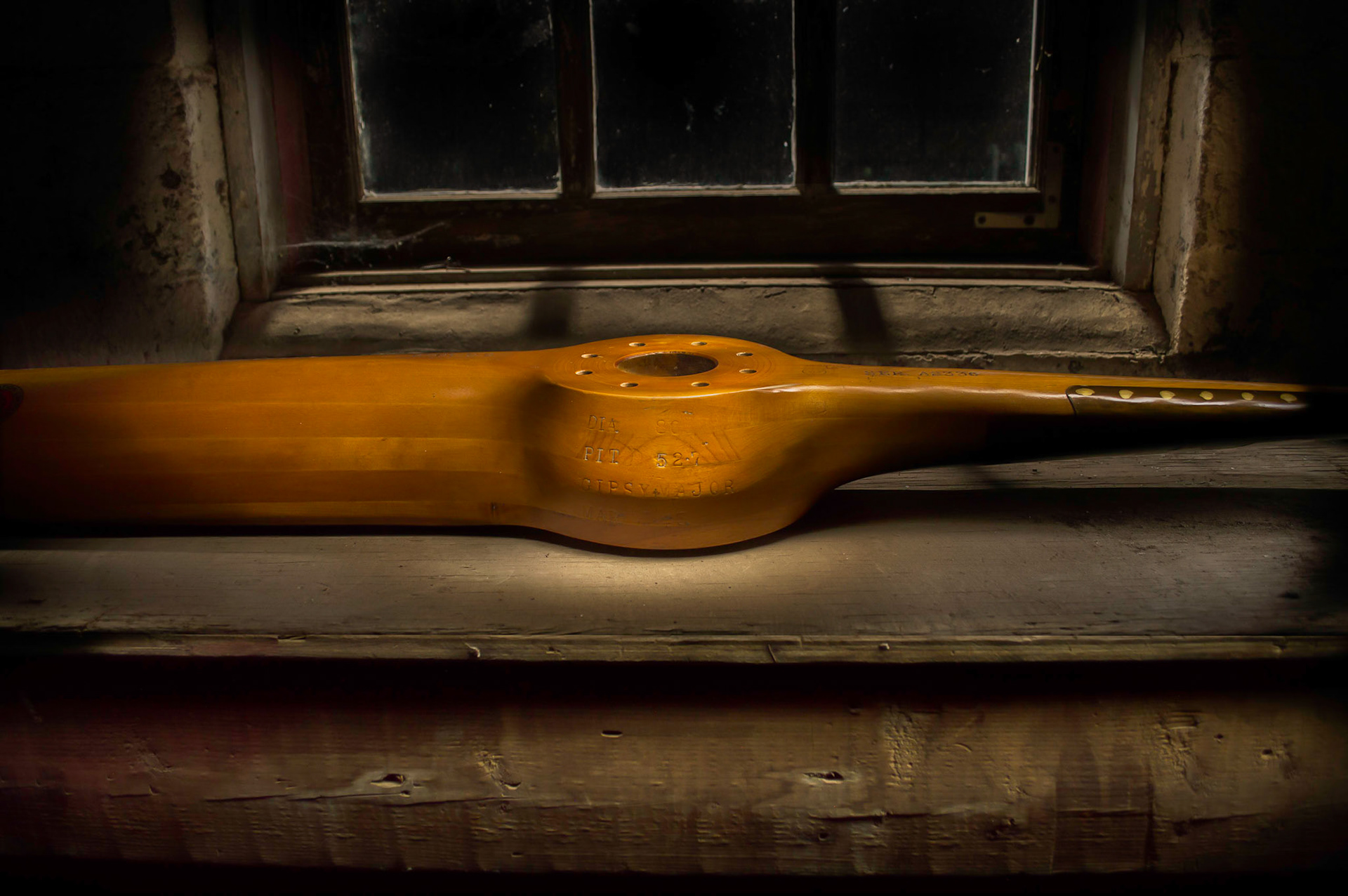 Light Painting of an old propeller from a Gyspy Moth by a shop window.