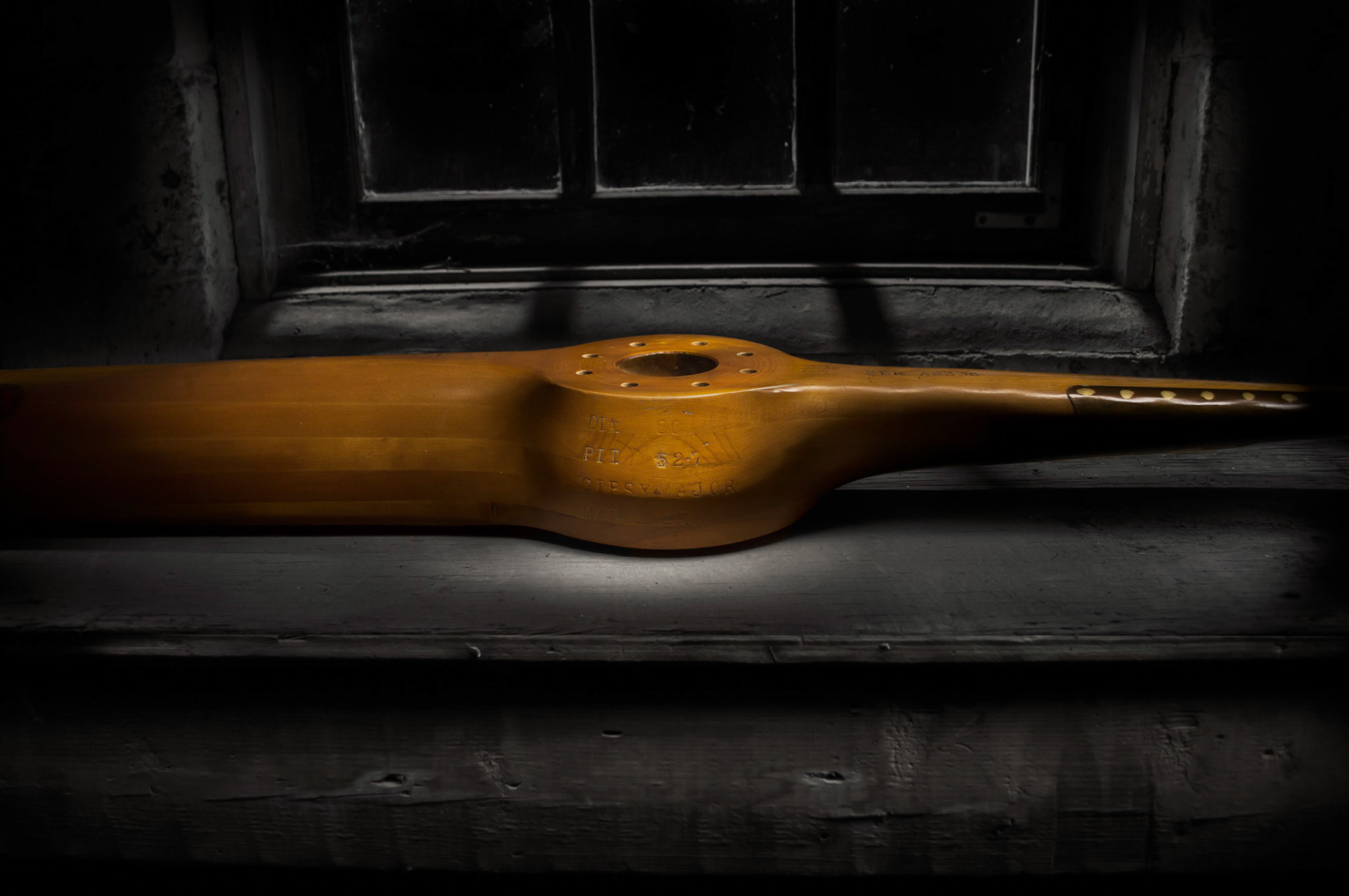 Light Painting of an old propeller from a Gyspy Moth by a shop window.
