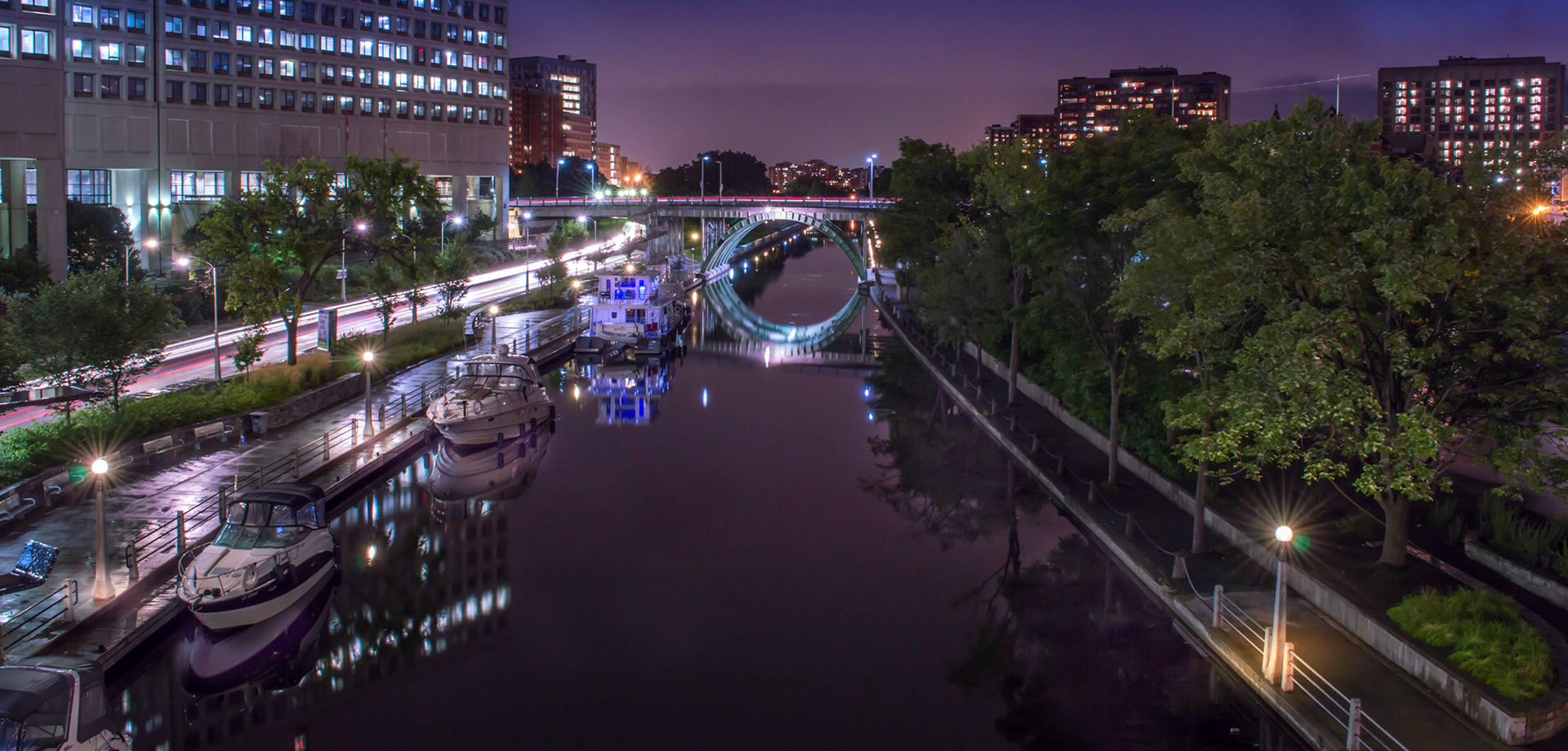Looking down the canal at the Laurier Bridge from atop the MacKenzie King Bridge. This one is cool because of the mirror like canal taking on a purple evening hue.