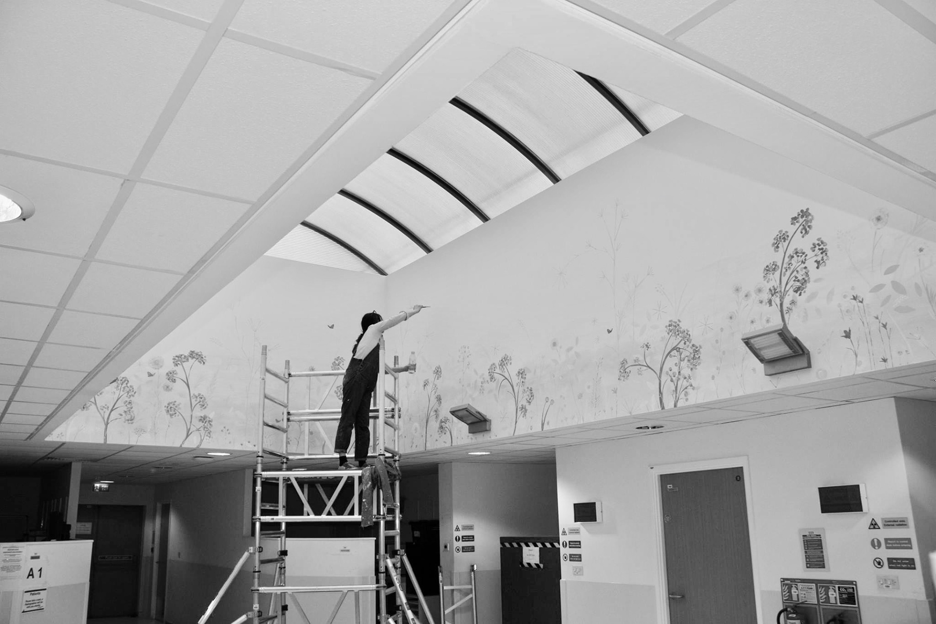 Lynne painting a mural
