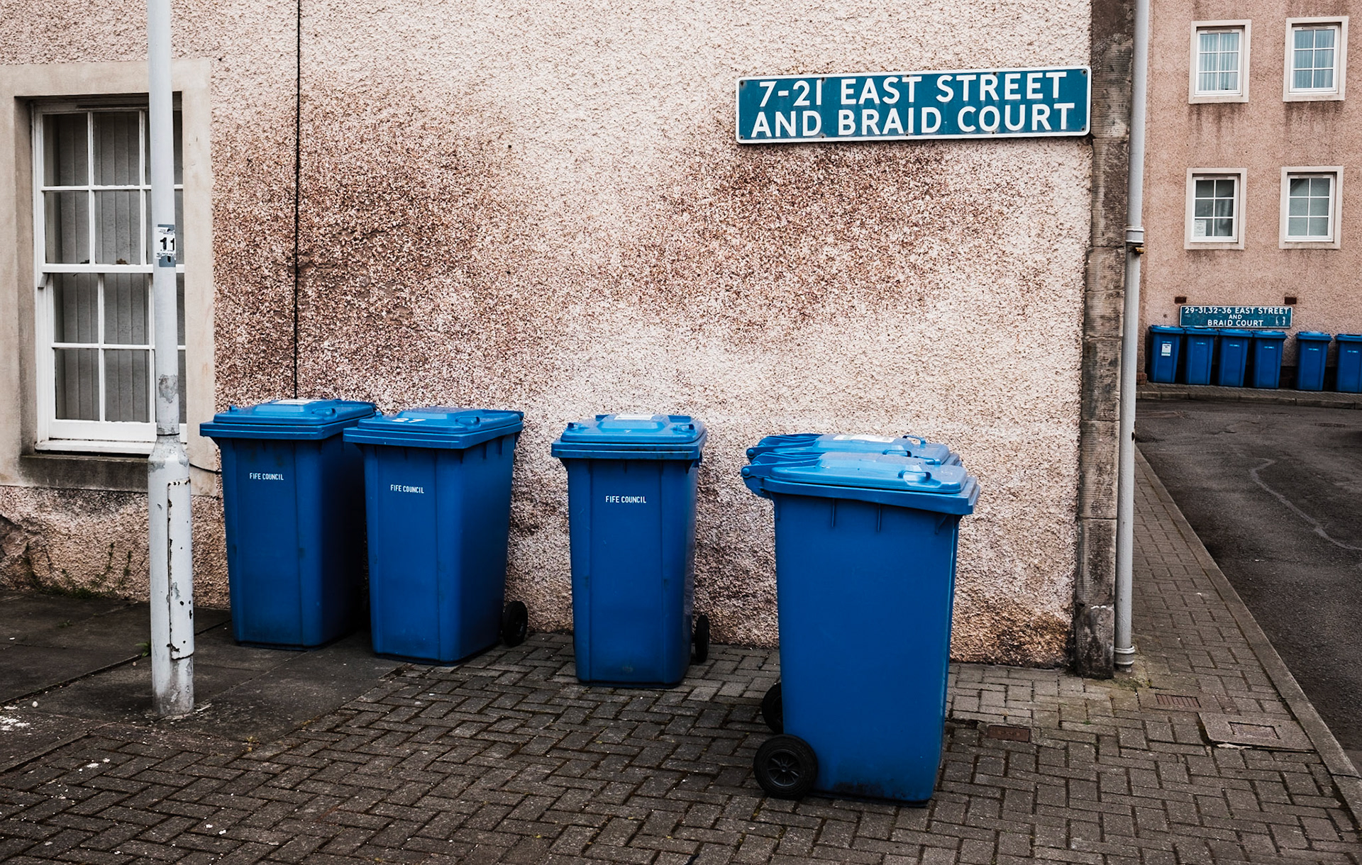 Rubbish bins are ready for collection in St Monans, Scotland/United Kingdom 2016. I try to document moments that feel notably real to me with images of this kind. Dumpsters are generally far too seldom photographed.