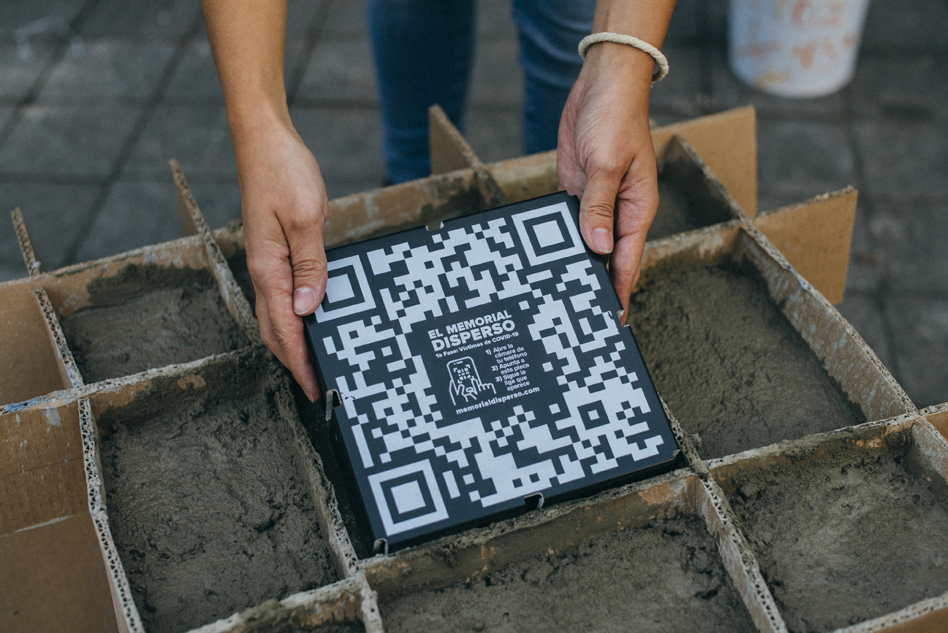 6 - La mezcla de concreto se vierte cuidadosamente en el molde, llenándolo hasta el borde, y finalmente se coloca la placa QR.
