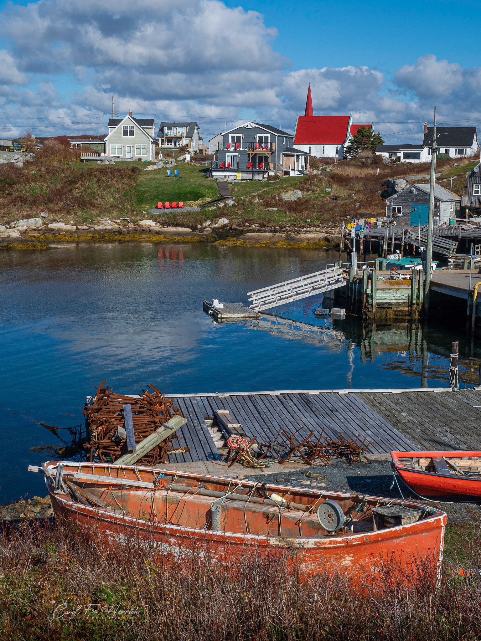 A view of Peggy's Cove where the two sides of the shore seem to contrast different lifestyles. The fishermen and the tourists. The doers and the watchers.