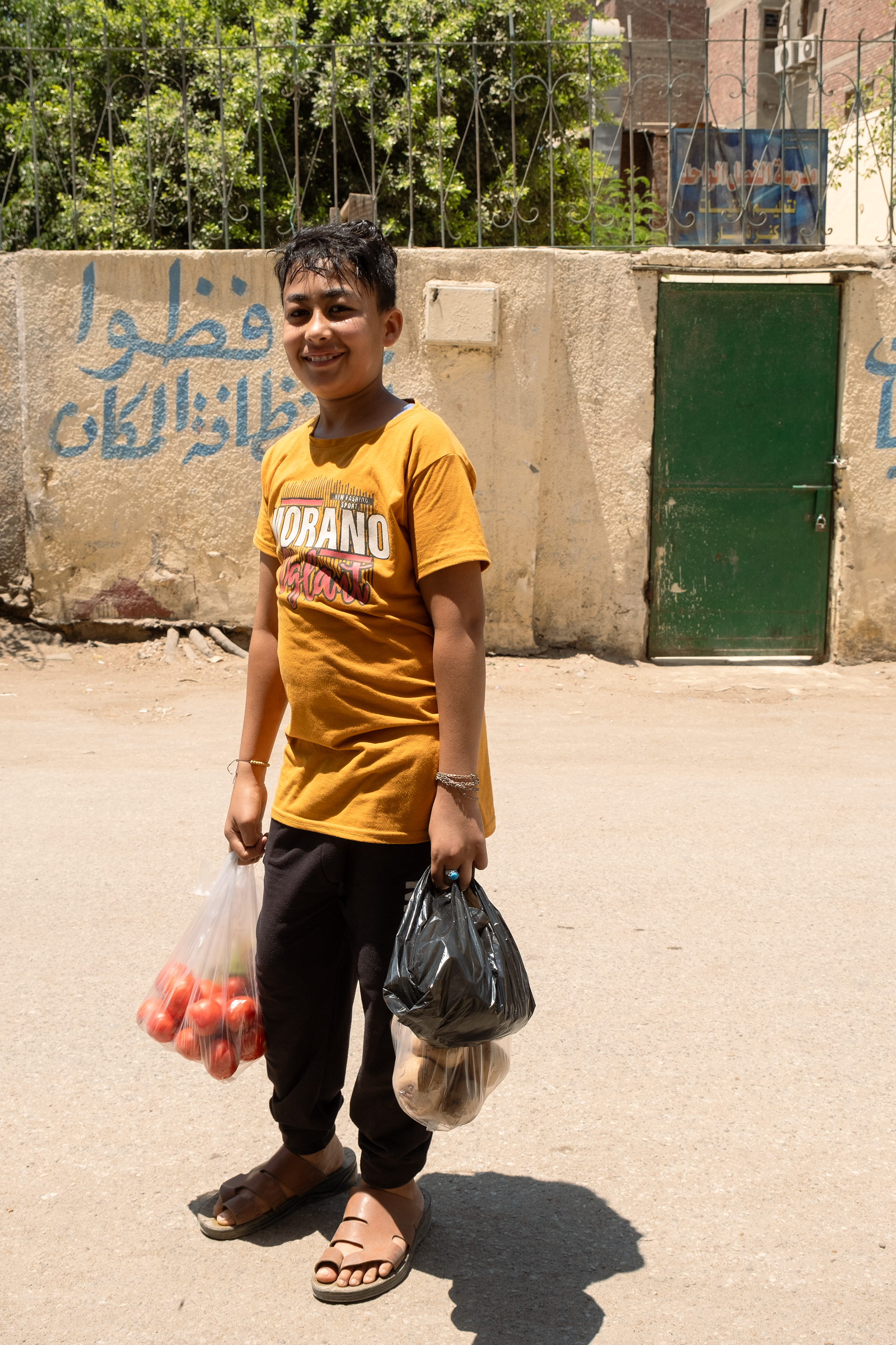 A boy carries the food home. Cairo, Egypt.