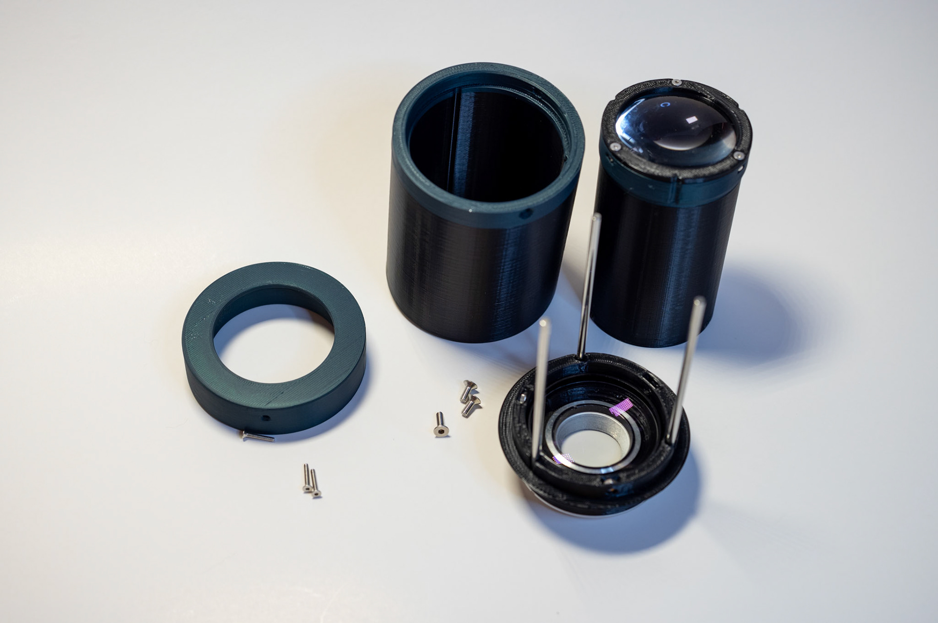 Disassembled lens showing rods and both lens elements