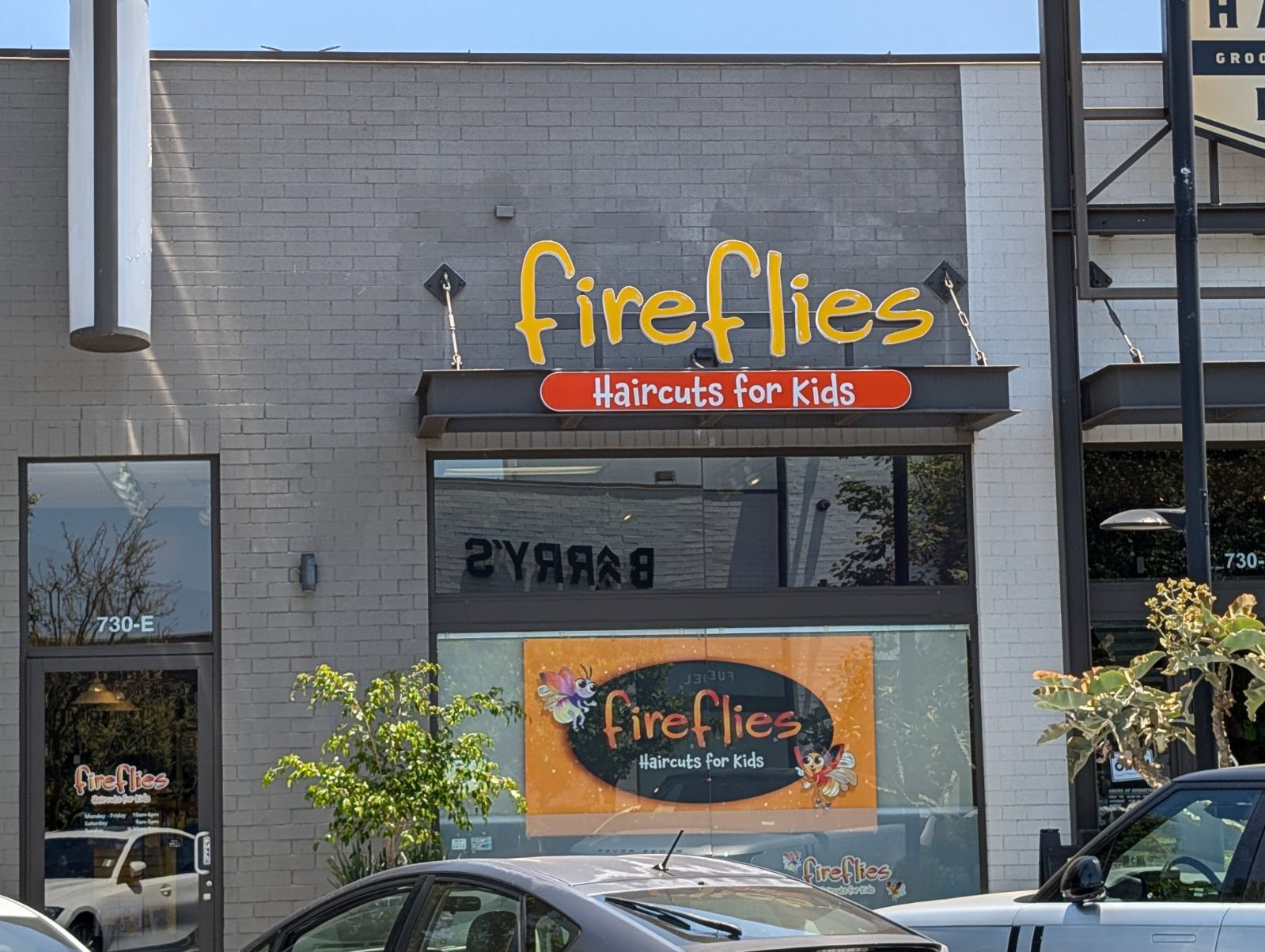Exterior Store Sign Fireflies Haircuts for Kids