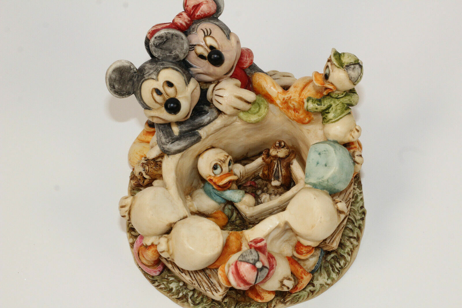 Interior of Harmony Kingdom sculpt, showing added detail and extending the story. See a Donald's nephew and a chipmunk raiding the picnic basket under the table.