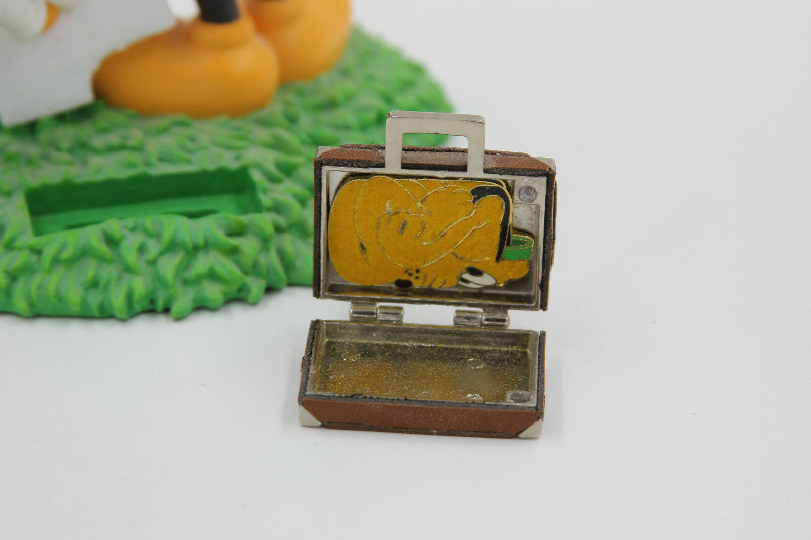 Disneyana Welcome Gift leather-clad suitcase pin opens to reveal a stow-away Pluto from the short 'Mr. Mouse Takes a Trip'