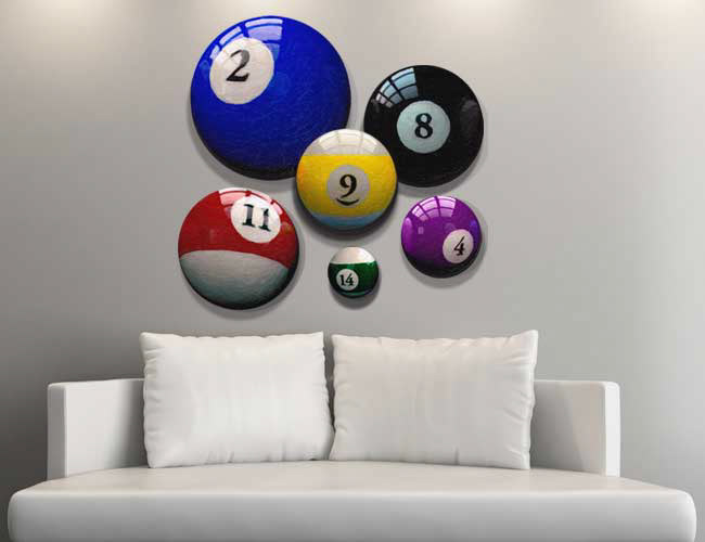 HangArounds Modular Round Canvas Wall Decor. White couch in front of white wall, where six round prints of varying sized pool balls are arranged as a unique wall hanging.