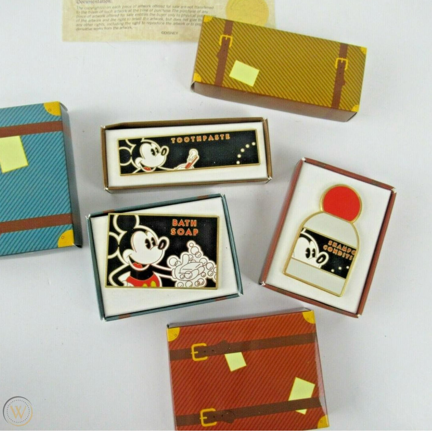 Inside the luggage packages are pins of Disney Resort amenities, which guests would collect as souvenirs.