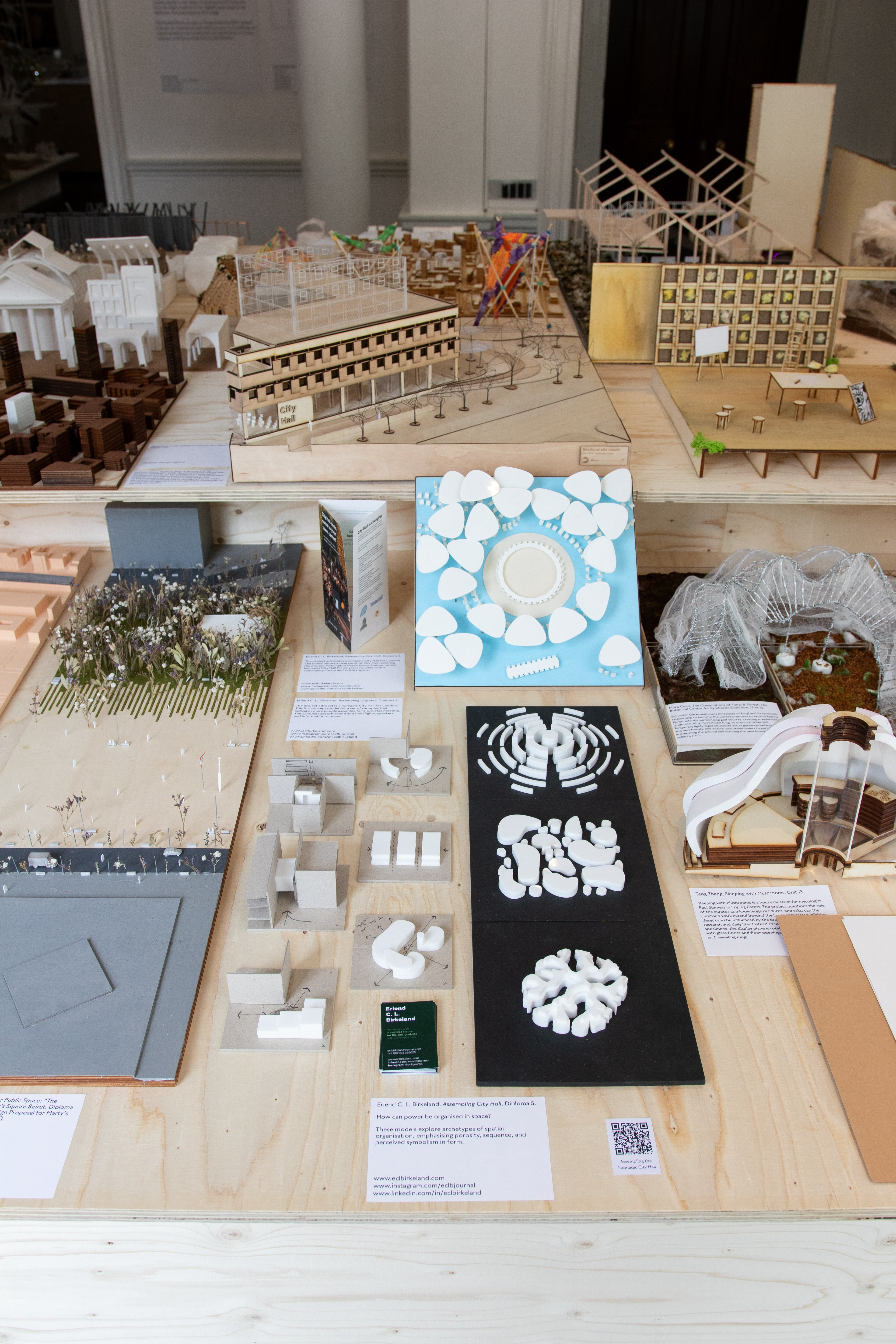 Models at the AA Projects Review exhibition table
