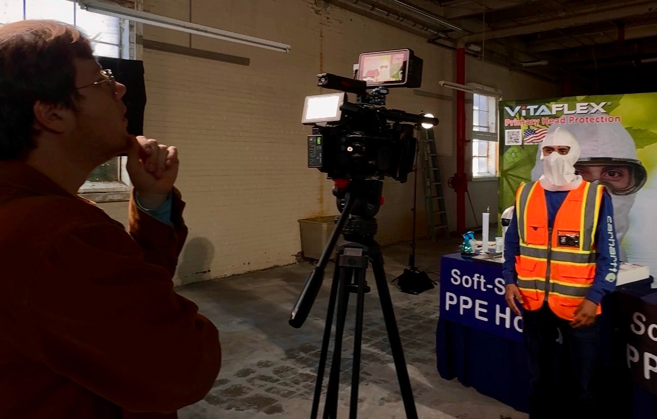 Filming a contractor in hard hat and hi vis for a safety training video