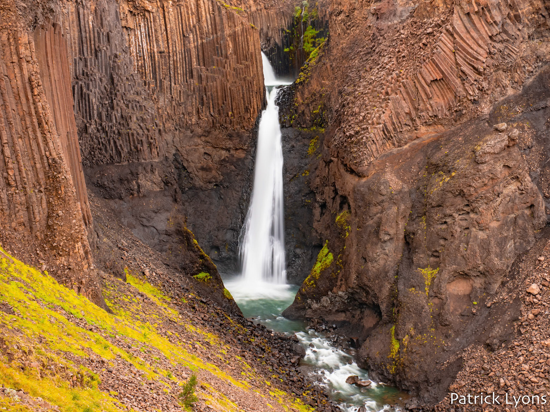 Litlanesfoss waterfall adorned with basalt columns in Iceland