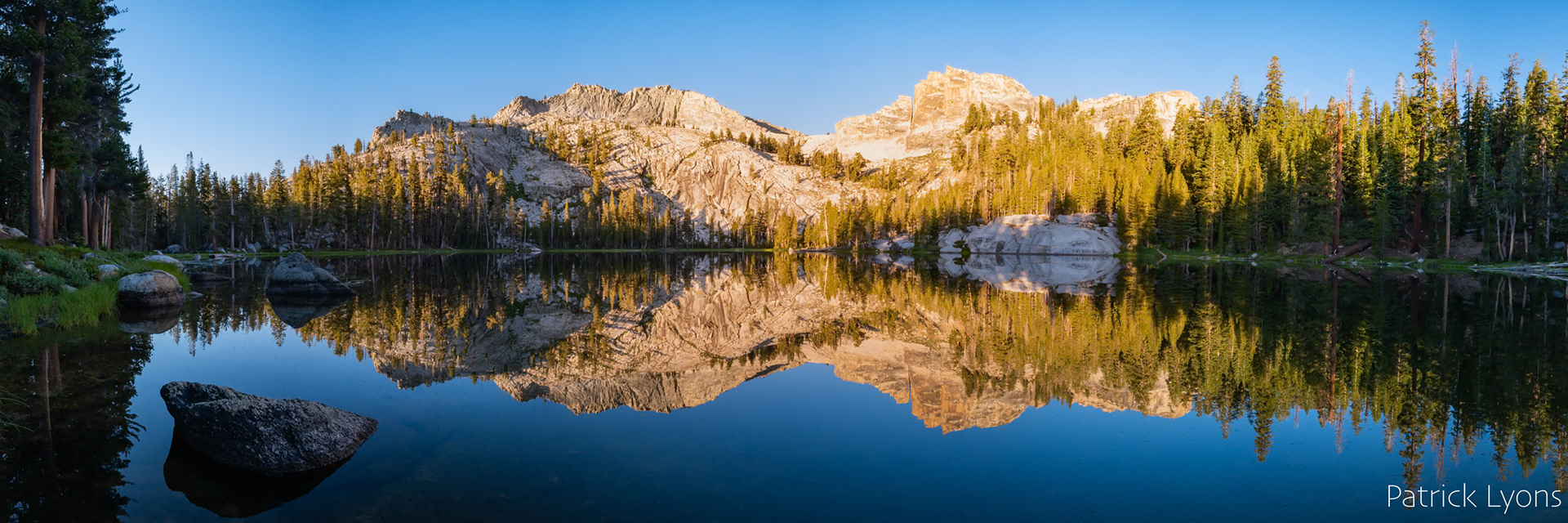 Panorama of sunrise reflection on Lost Lake in Kings Canyon National Park