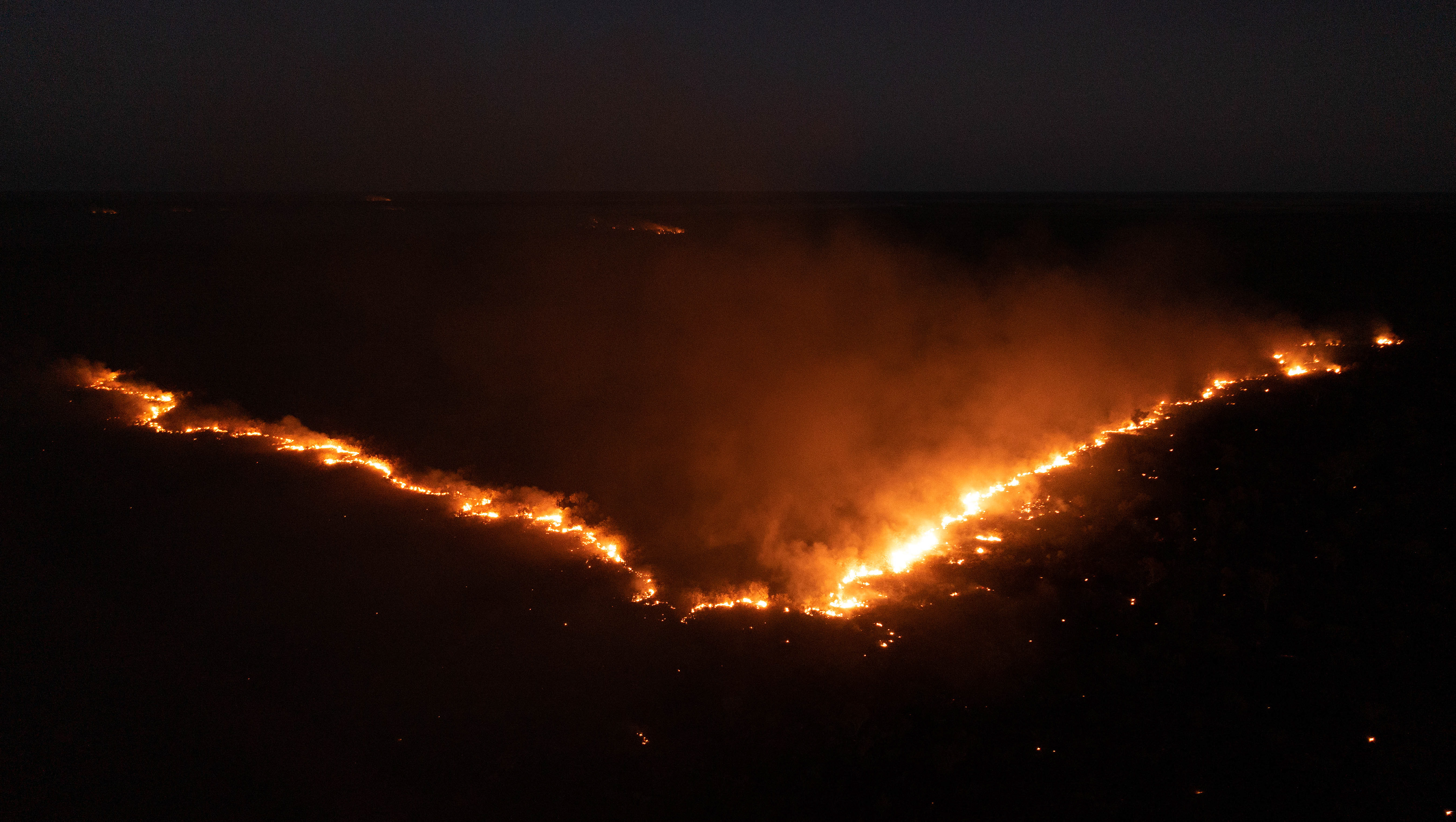 Dancing flames illuminate the night sky, illustrating the ancestral stories of the Fire Dreaming Wayne Quilliam