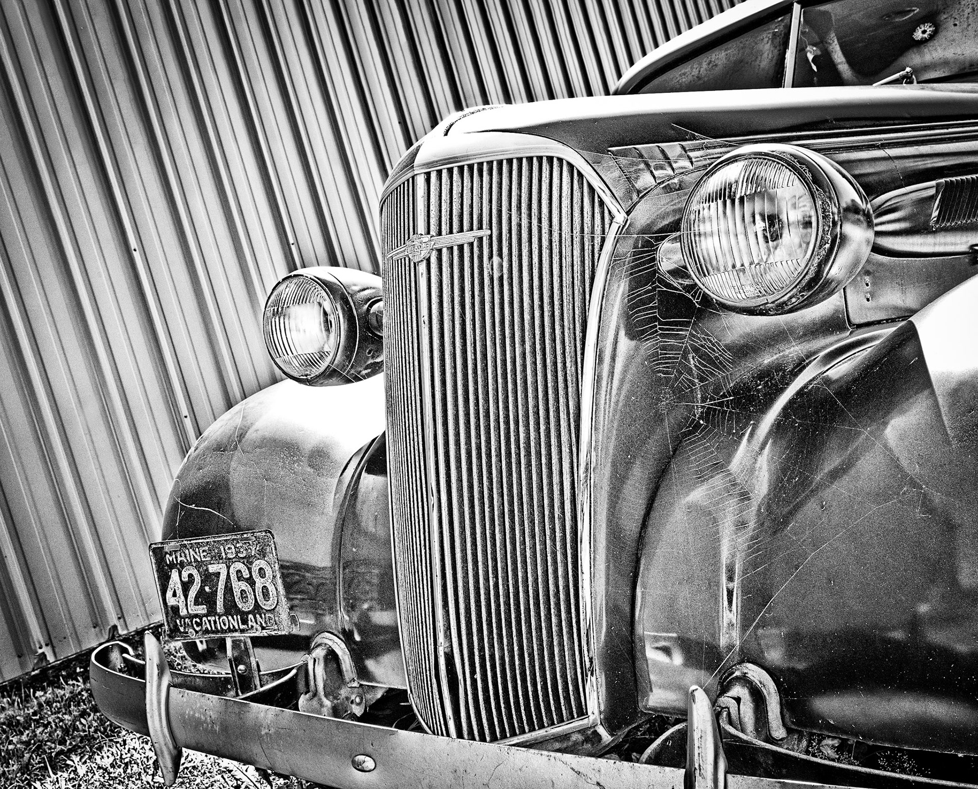 This old abandoned car, with its "Vacation land" license plate and bullet holed window, seemed to speak of a long ago vacation gone terribly wrong.