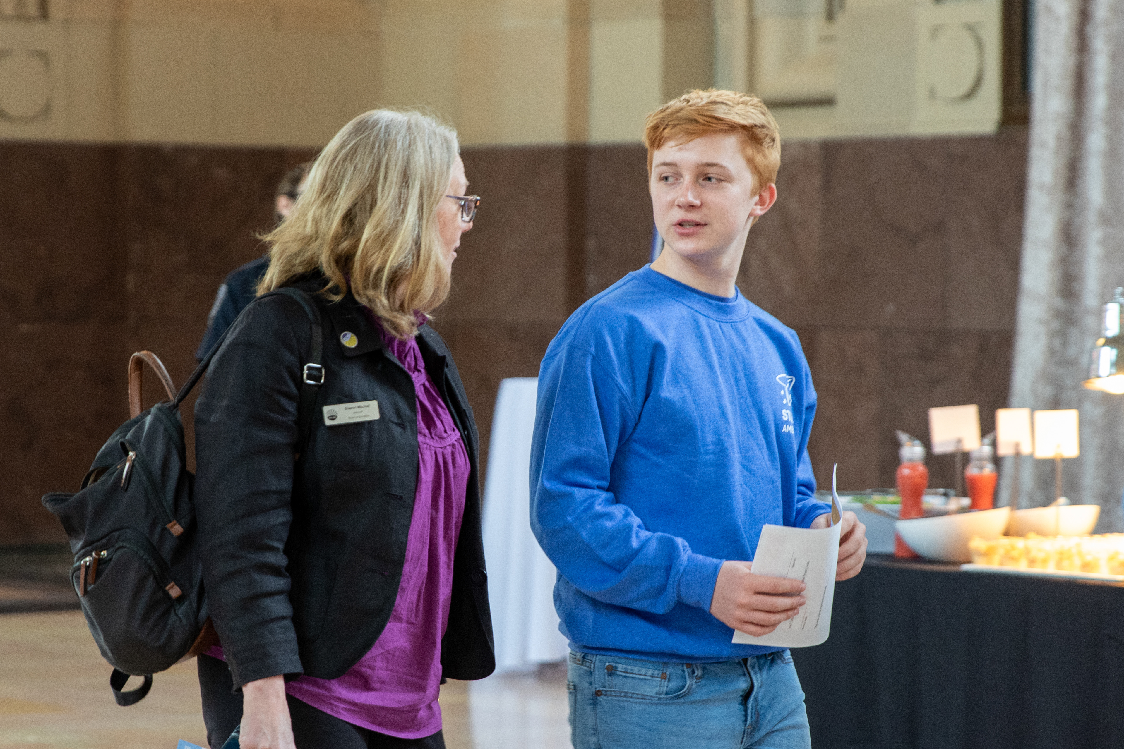 Students welcome professionals to their Get On The Bus event. The students were able to guide guests to their tables while sharing about their own experiences. 