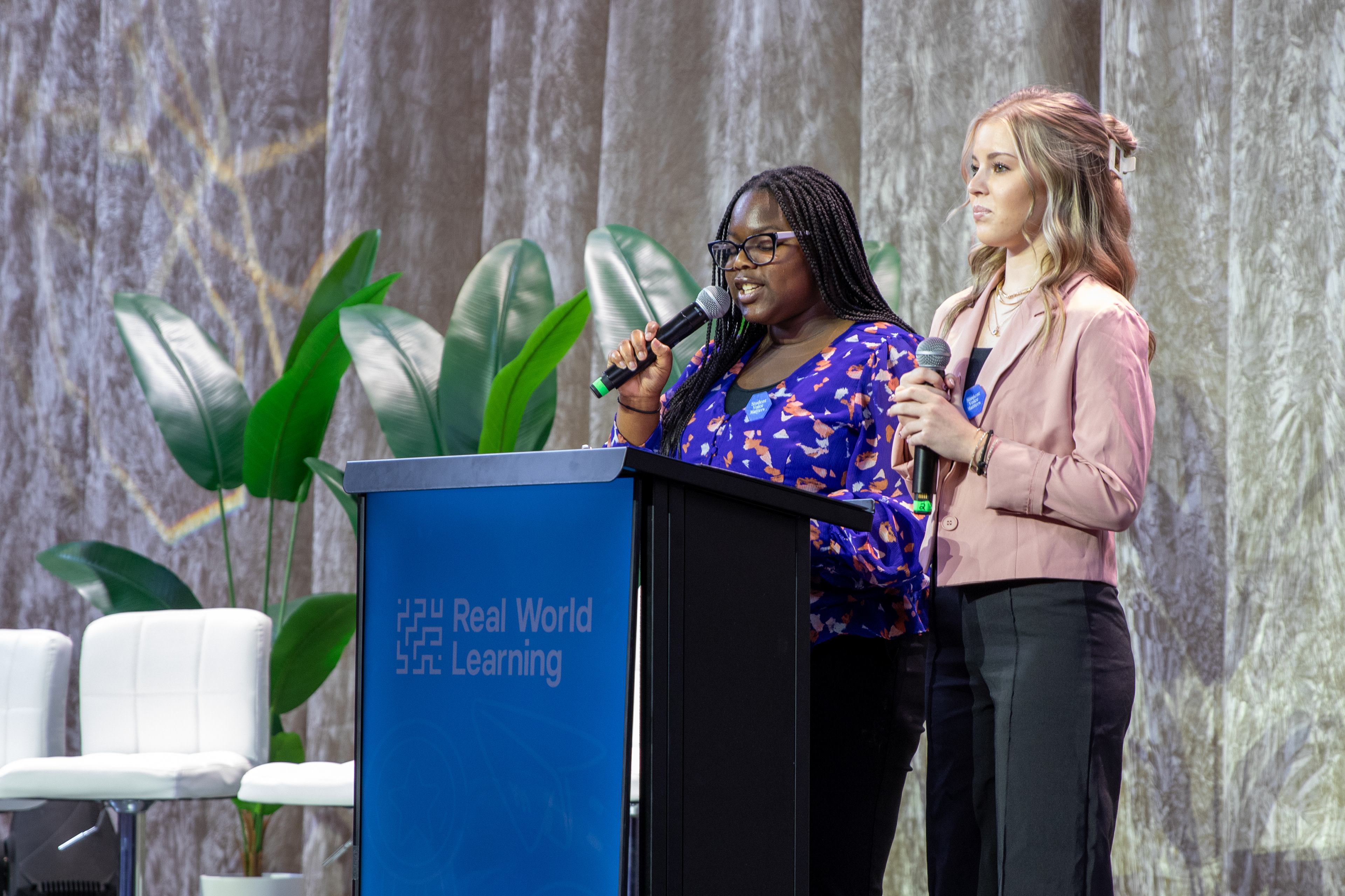 Obiamaka Obiesie and Mackenzey Spiller, Student Voice Captains, are invited to the stage to present the next award. 