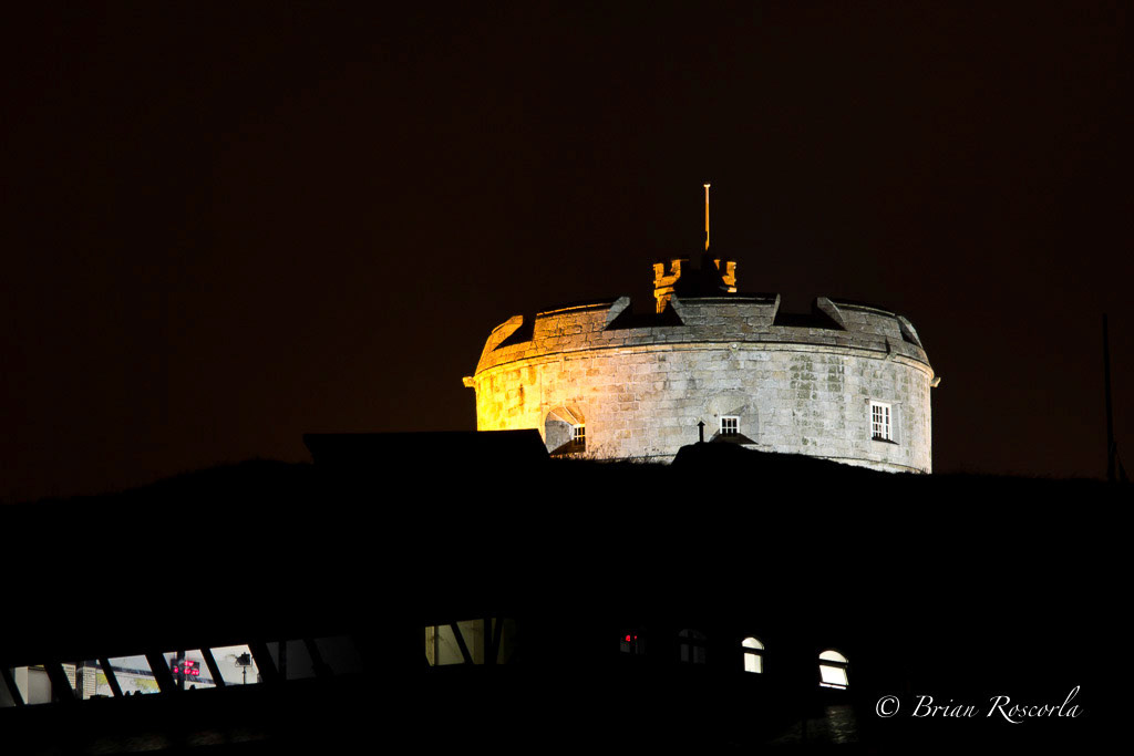 Pendennis Castle at night with the Coastguard Station in the foreground
