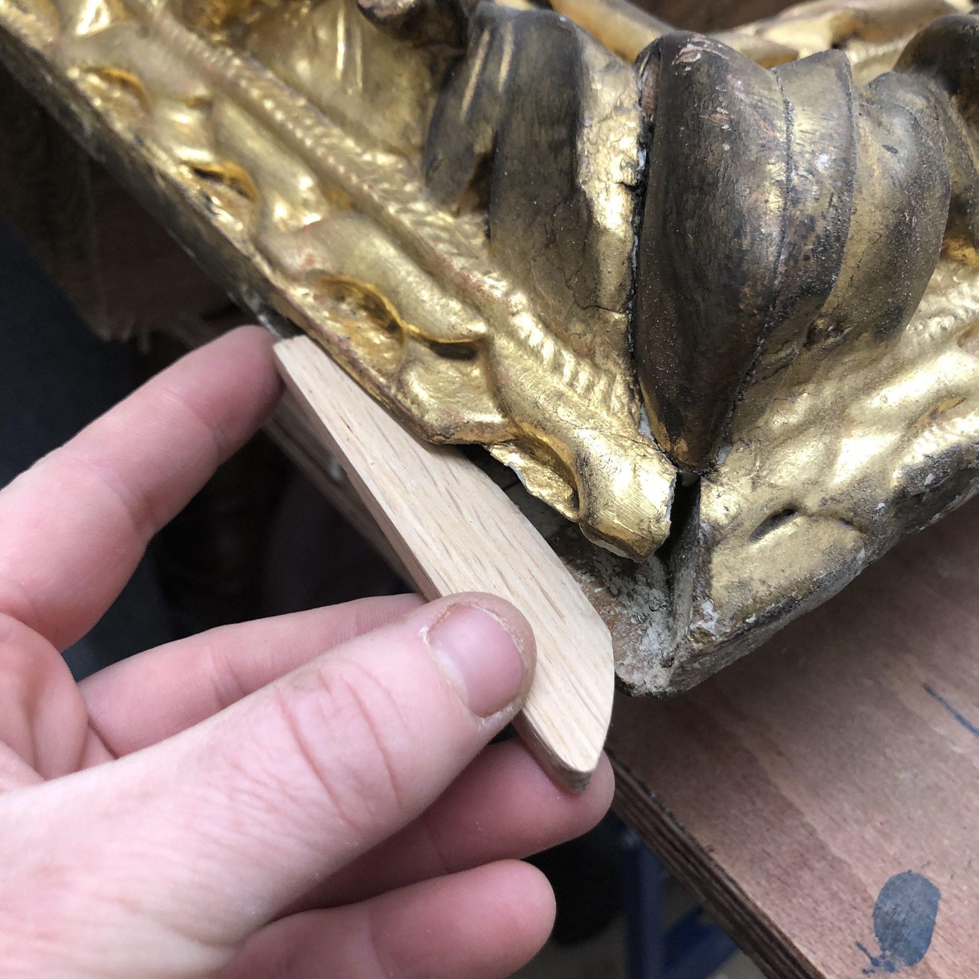 fashioning a new piece of wood for missing corner section