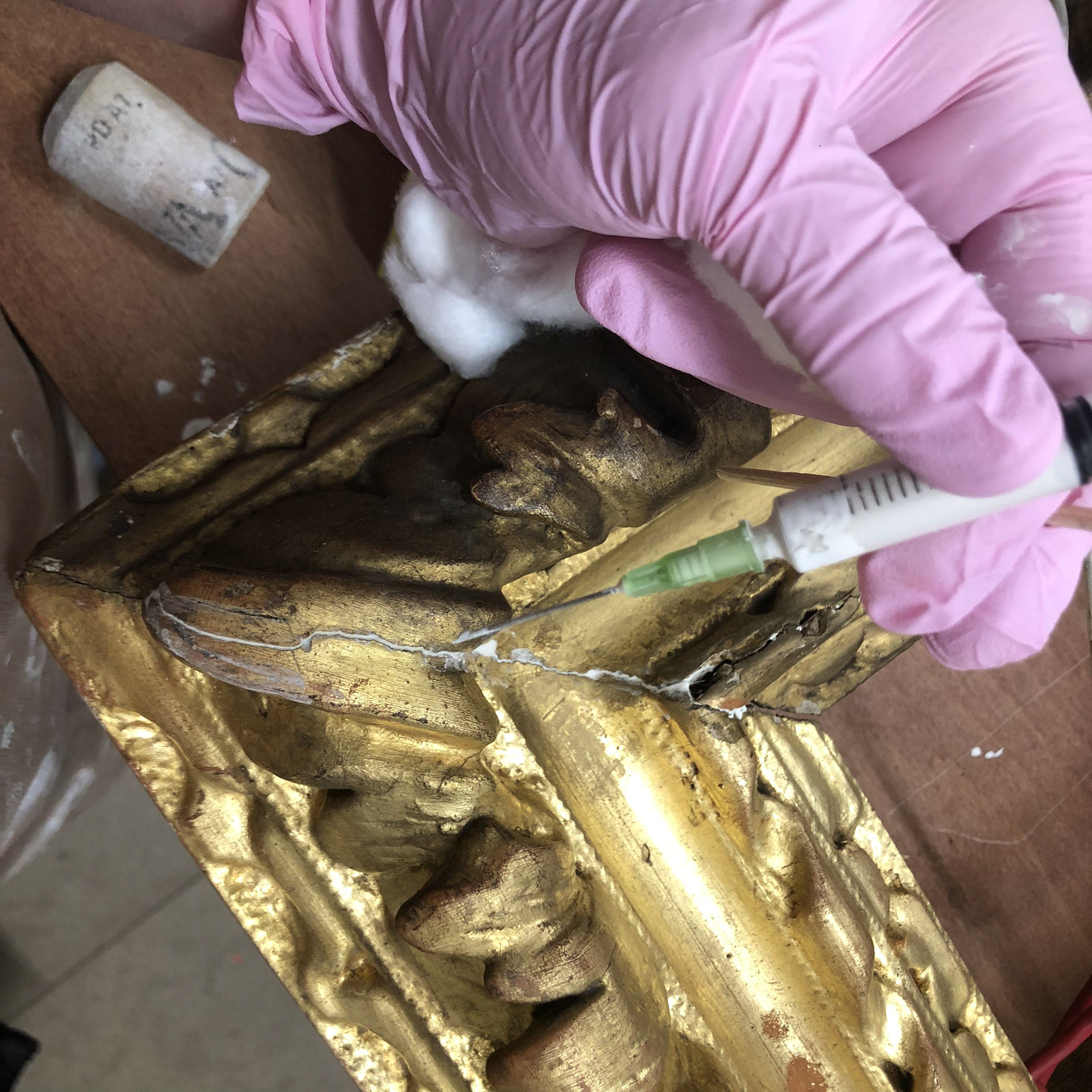 injecting gesso into the cracks