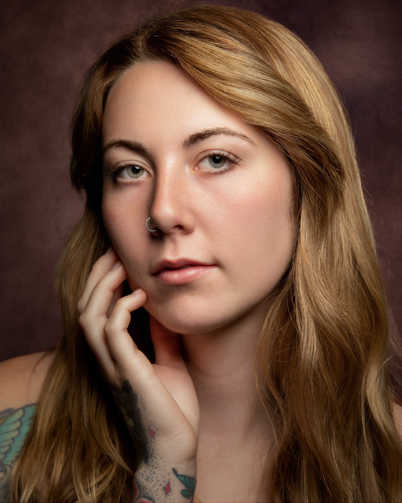 A strawberry beauty, her captivating allure lies in the unique blend of elegance and fiery softness.