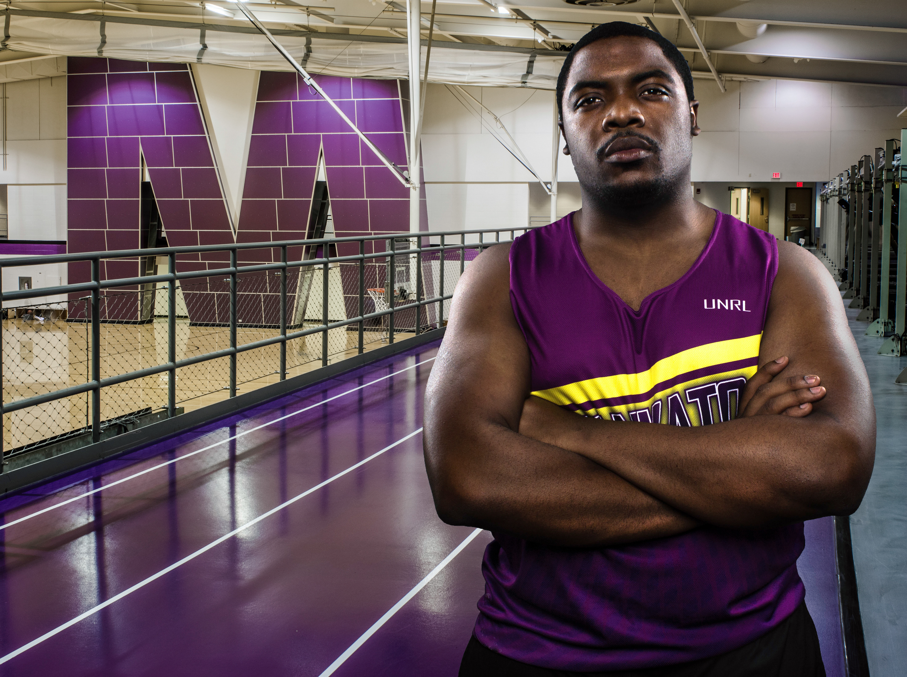 muscular man standing on running track at MNSU