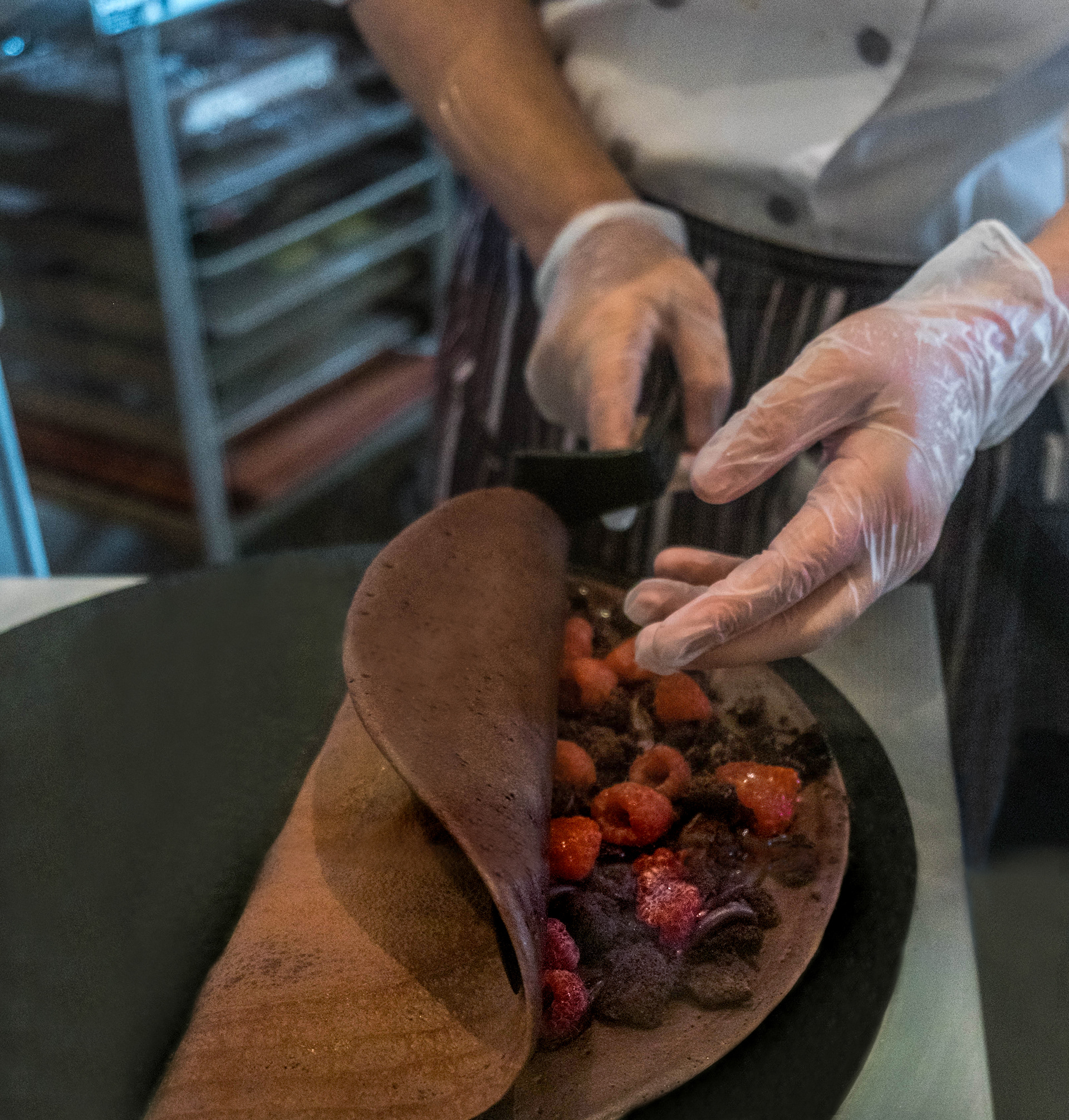 pastry chef making chocolate raspberry crepe