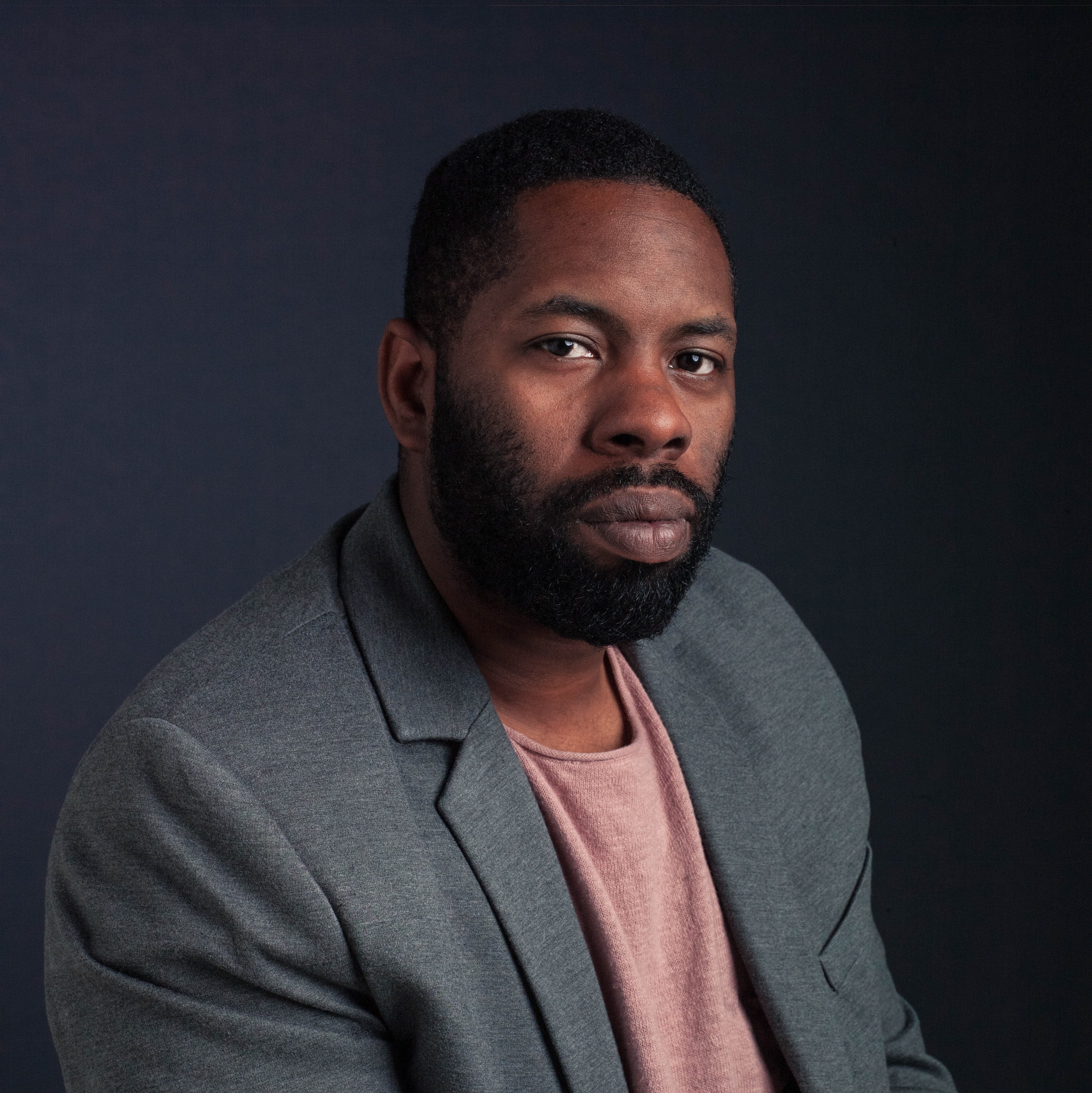 man wearing blazer posing for headshot