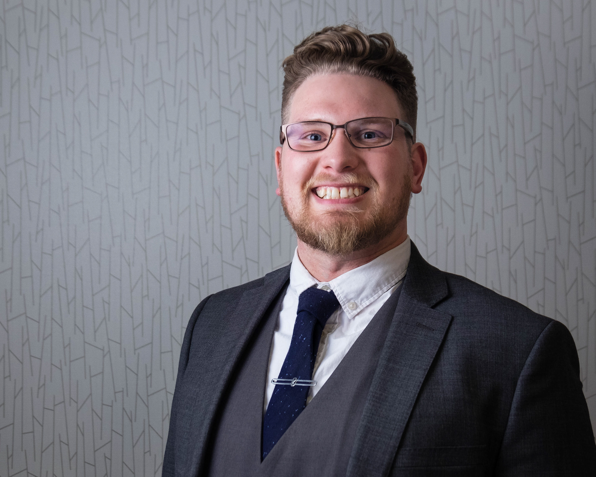 man wearing a business suit posing for headshot