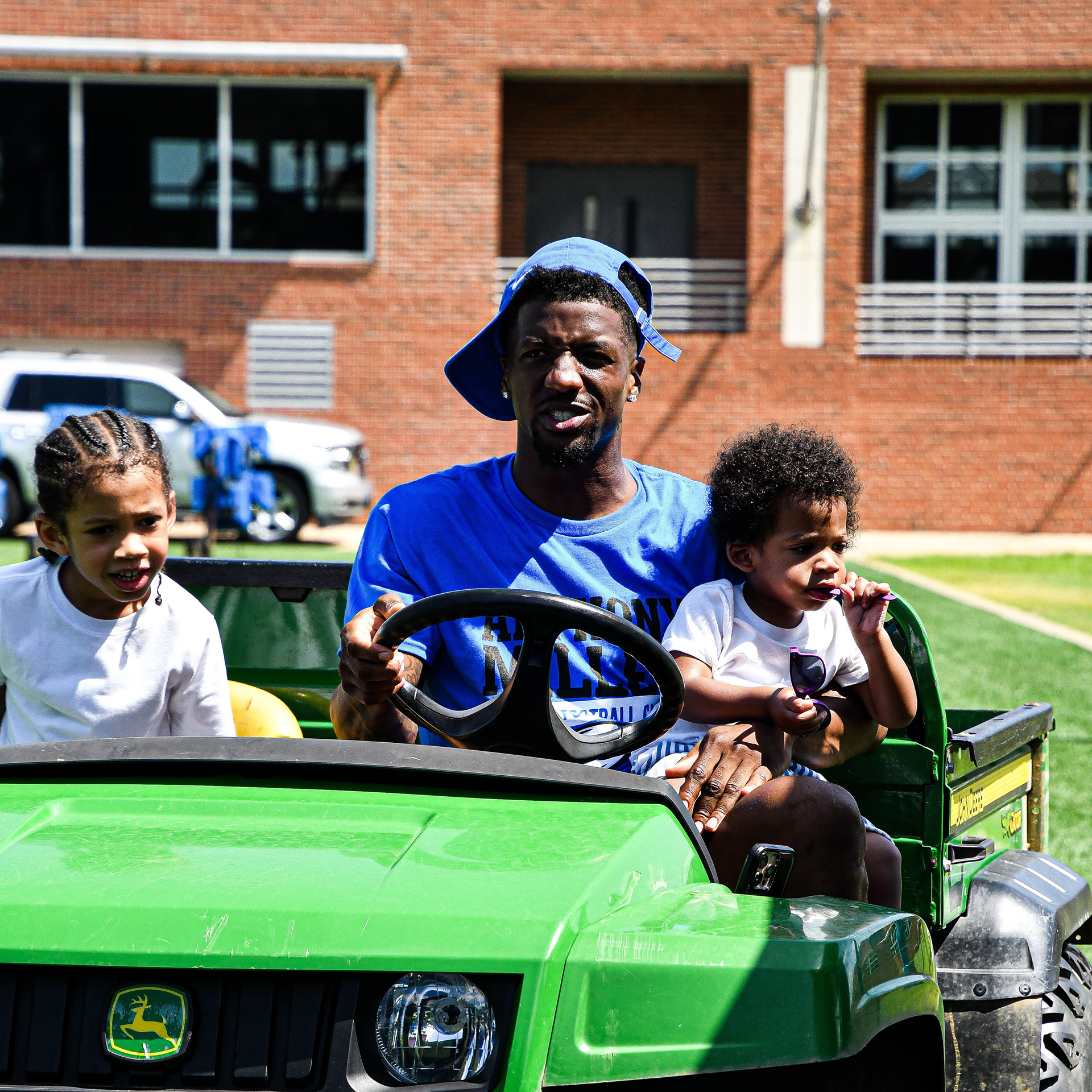 Anthony Miller and his kids on a John Deere gator