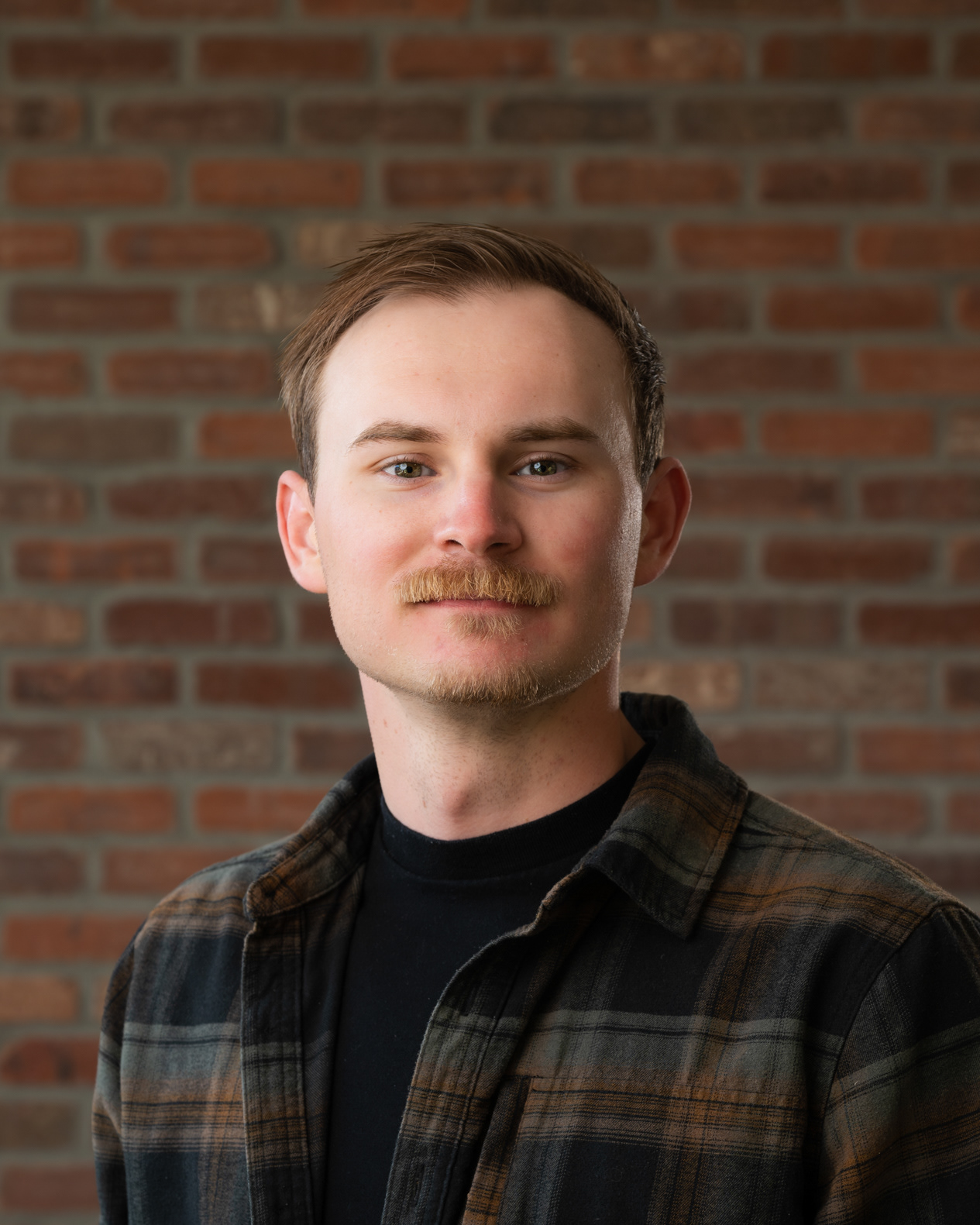 A professional studio headshot of the photographer behind needleframe, Sean Betz.