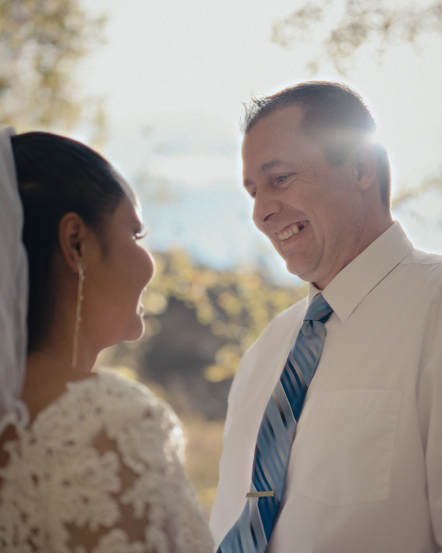 Bride and groom sharing a laugh during their intimate outdoor ceremony in Pocatello, Idaho.