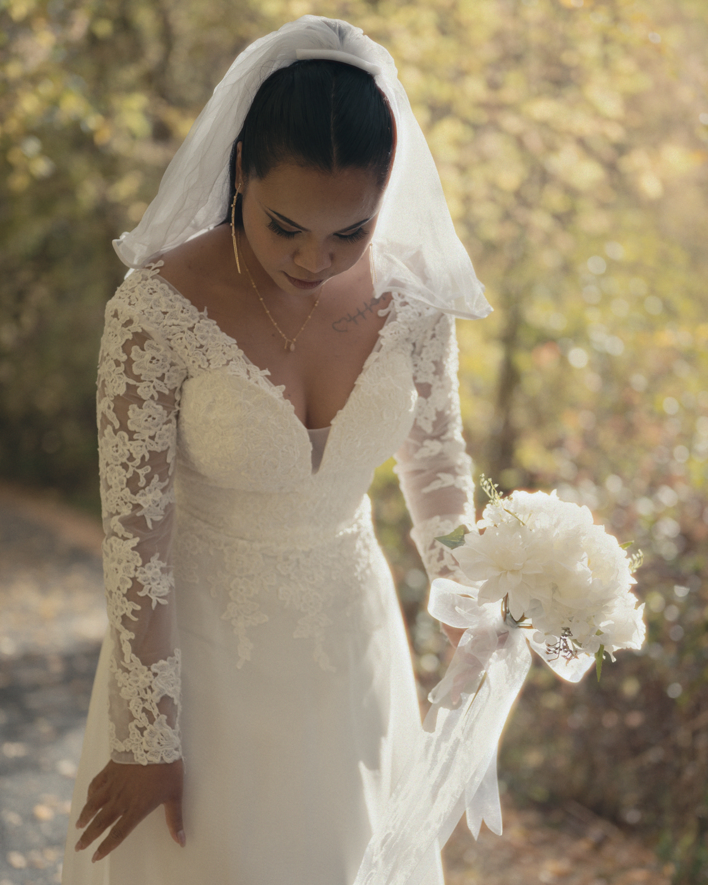Bride standing among fall trees before her ceremony in Pocatello, Idaho.