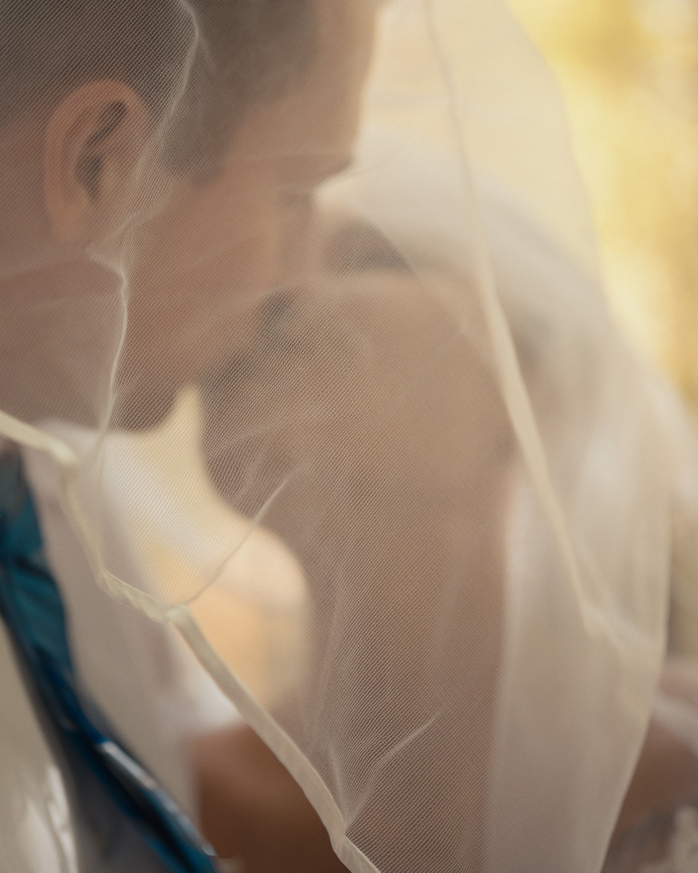 Bride and groom sharing a quiet moment under her veil during golden hour in Pocatello, Idaho.