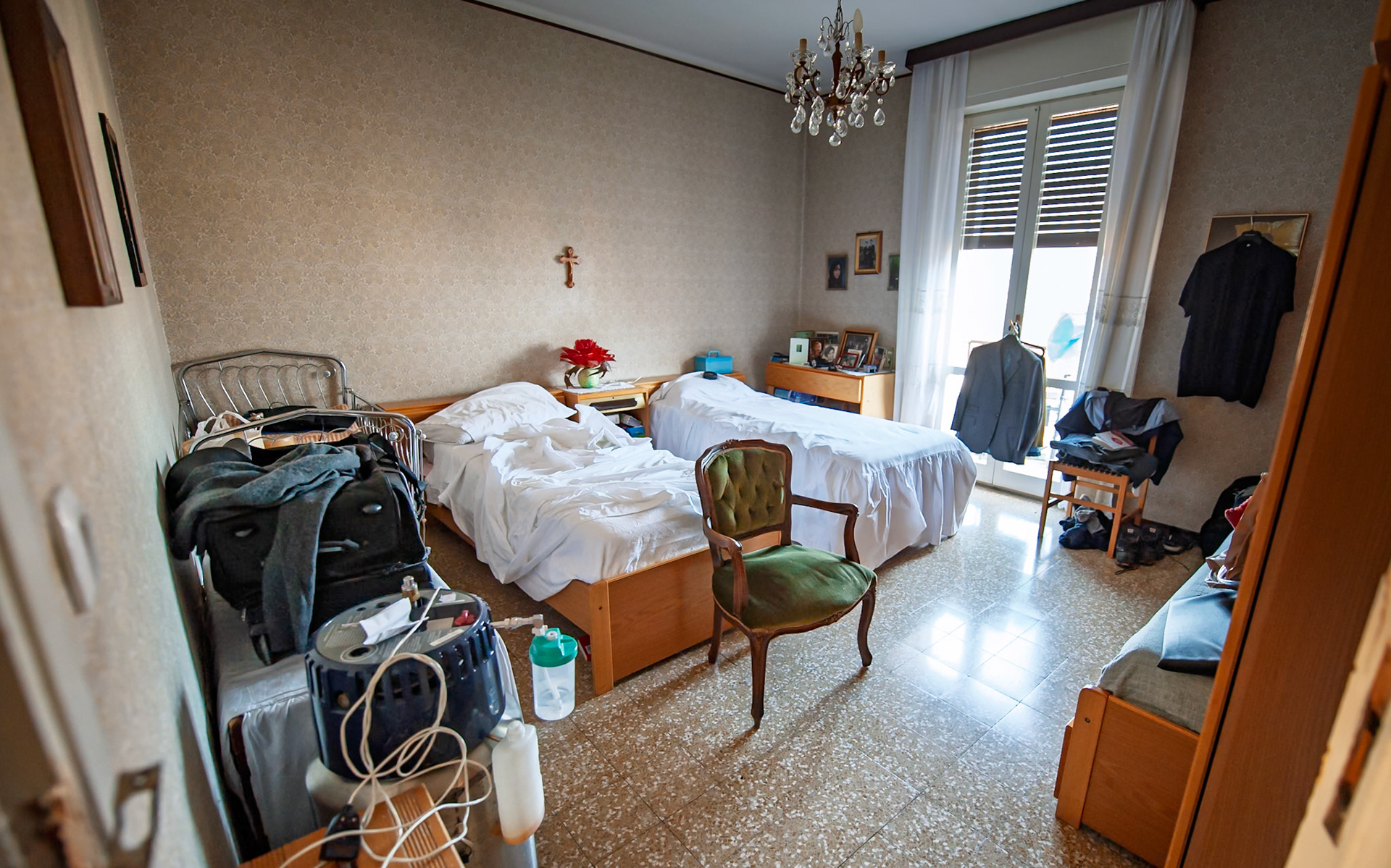 Nonna's other bedroom.  I slept here too during my visits when I was older.  Here you can see elements of the chaos of her passing.  My clothes strewn everywhere.  My funeral suit handing on a door handle.  And Nonna's oxygen tank on the bottom left. 
