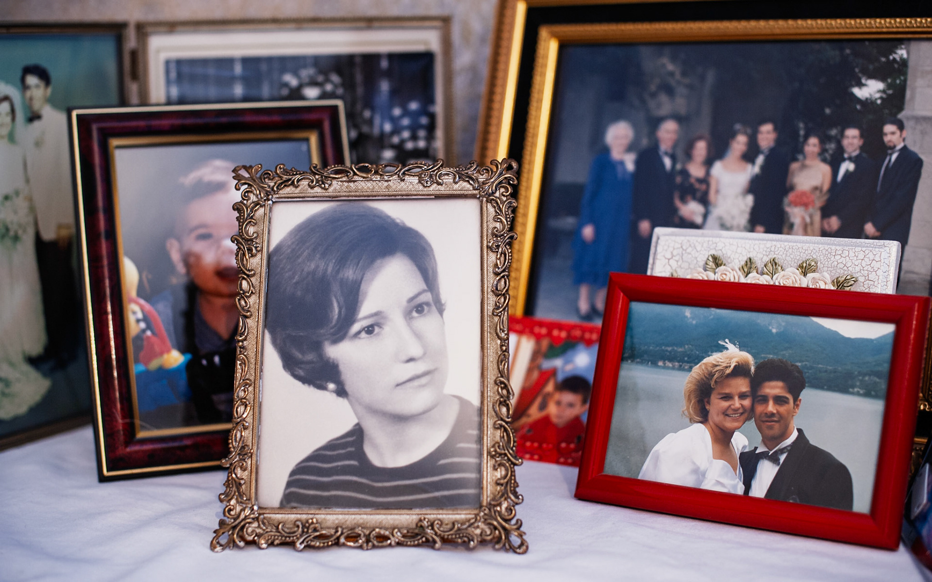 Family photos on a dresser in Nonna's guest bedroom.  She was so proud of her big family, and this is how she kept us close.  My parents' wedding photo is in the background on the left.  My sister's wedding photo is on the back right.  She flew to the U.S. to attend this wedding but was forced to fly back to Italy when my Zio Saverio, her son, died of a heart attack on my mother's birthday.  Nonna was devastated and never traveled again after that.  In the front is a photo of my mother at the age of 17 or 18.  