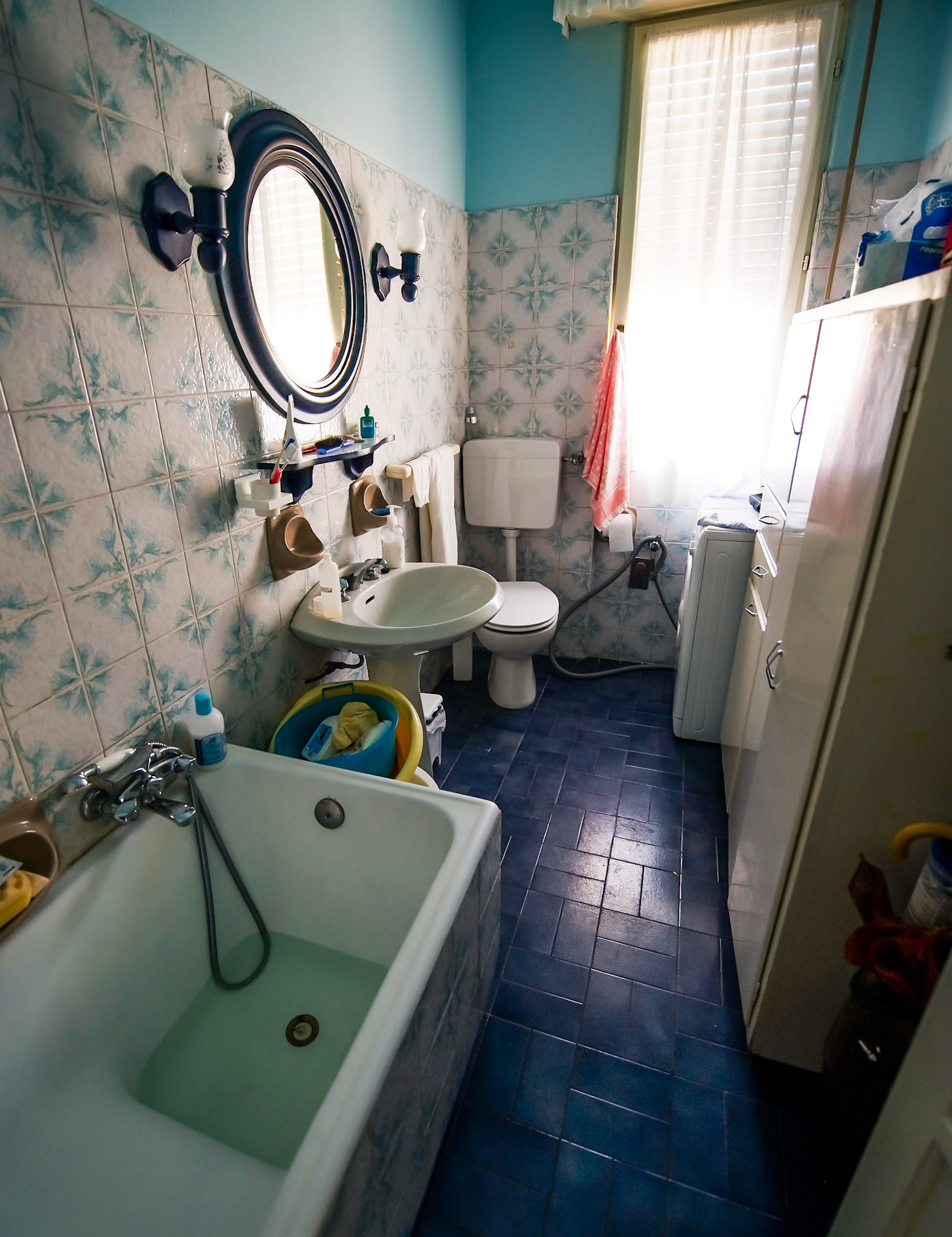 Nonna's bathroom.  Who takes pictures of a bathroom? It may seem strange, but this was one of the only oases in an often chaotic house full of people.  I remember getting spanked by my great-grandmother, Nonna's mother, in that bathtub, along with my cousin, when I was 6 years old.  He had convinced me to go swimming in a dirty pool of water behind Nonna's house after a rainstorm.  Nonnina saw us from the balcony, called us inside, and then spanked the living shit out of us while washing us clean in this bathtub.  She looked frail but had a bewildering strength that shocked me into compliance with her future demands.