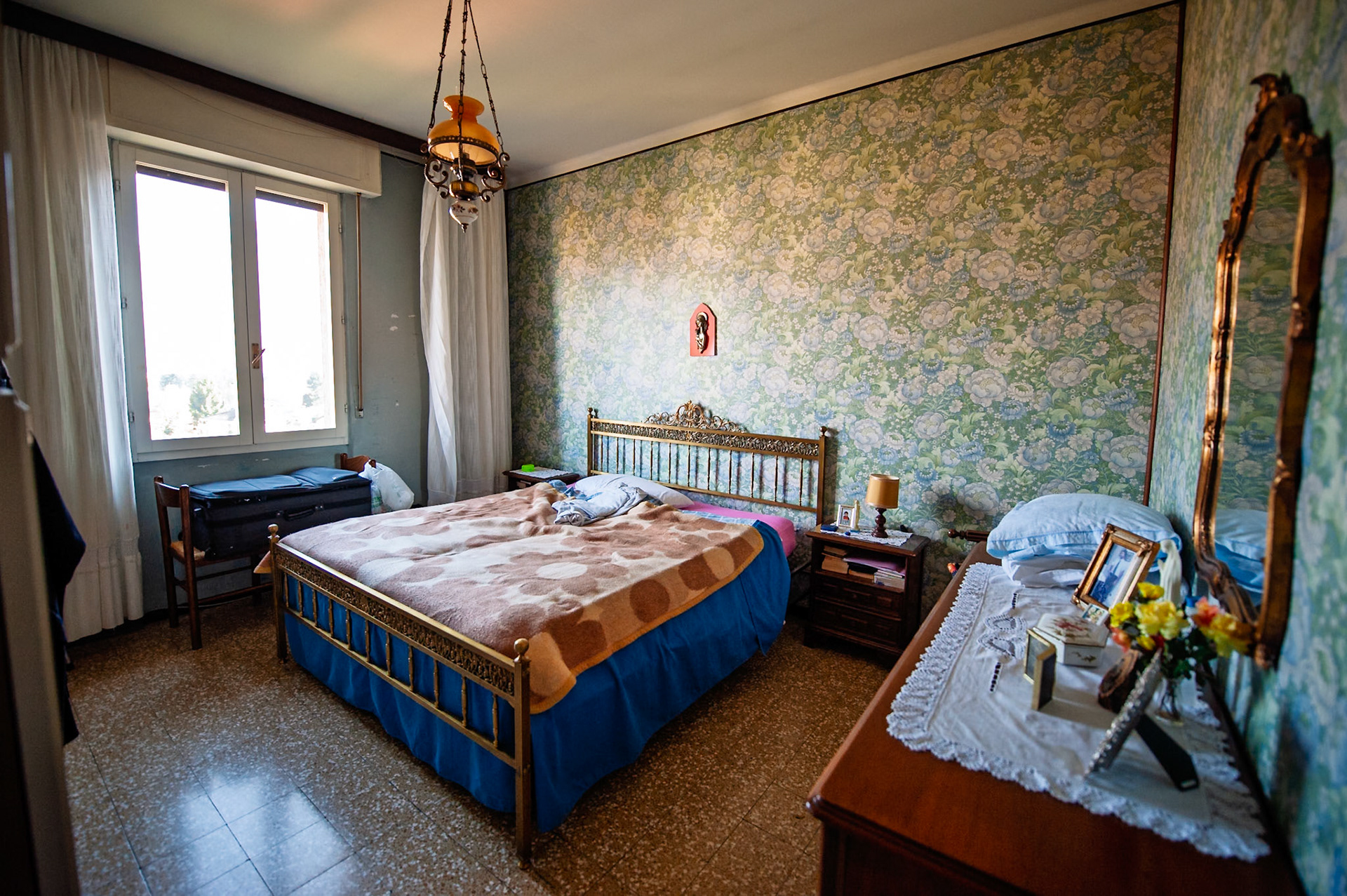 Nonna's bedroom.  This is the room they emptied out and kept her body in before they buried her.  This is the room we slept in during our visits as kids, all crammed into that bed.  This is the last place I saw Nonna's physical body.