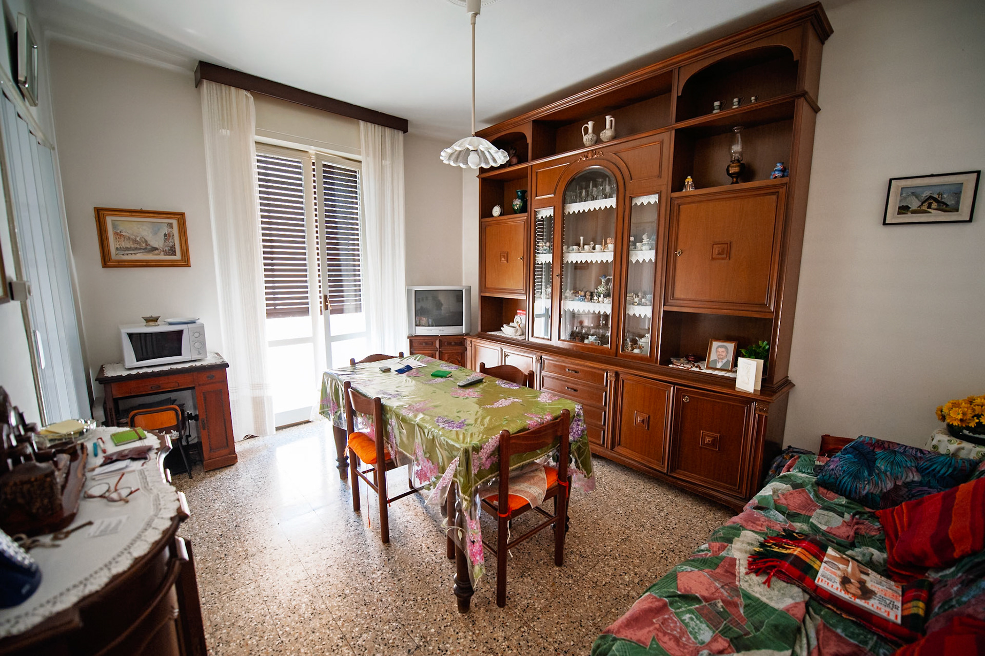 Nonna's living room and dining room.  The scene of many family meals, conversations, arguments, laughter, and memories.  I had my 6th birthday here with my entire family, including Nonno, who was still alive then.  An incredibly bittersweet image.  