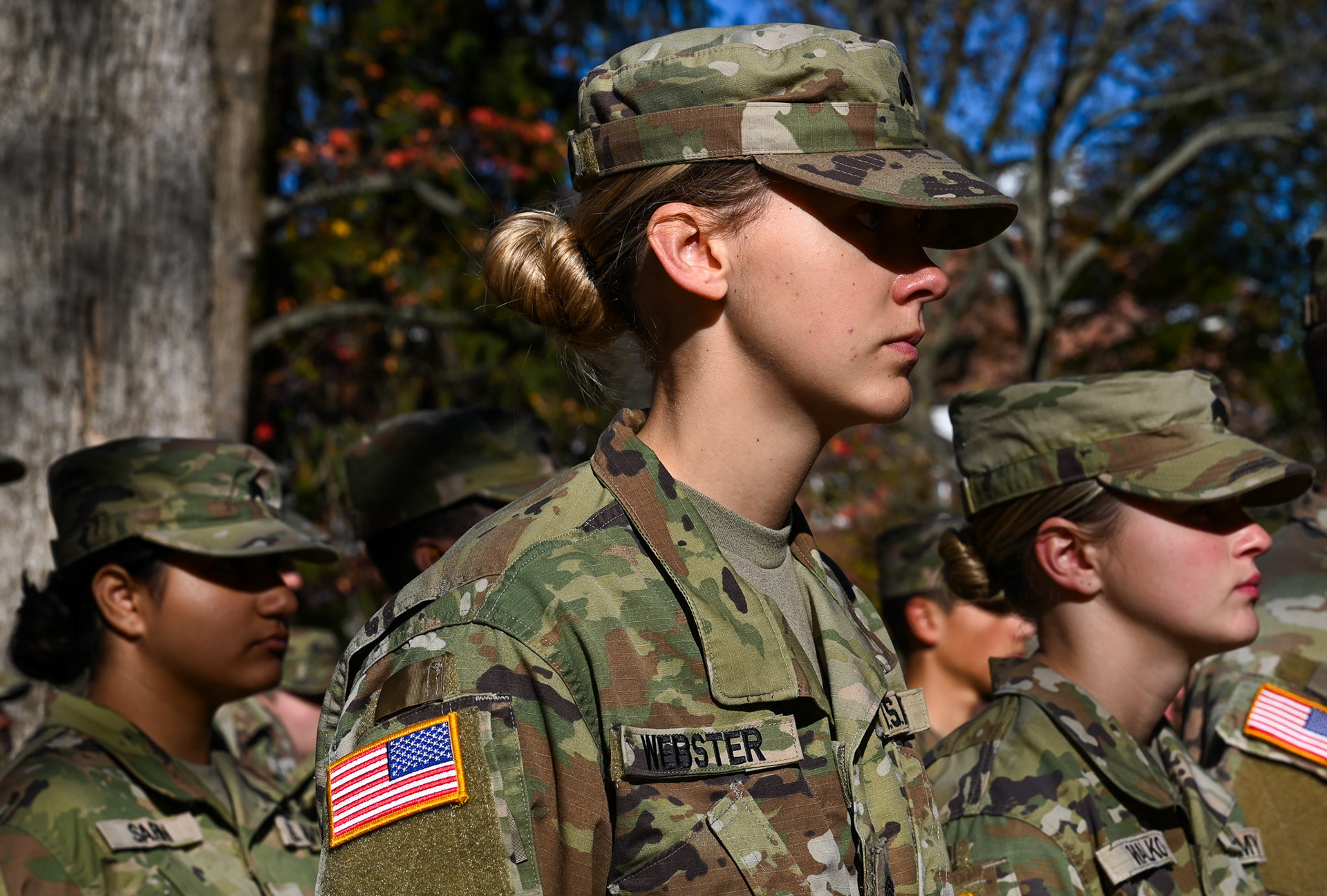 Bobcat Battalion Cadets, from left, Srishti Lahshmi, Kerstin Webster, and Sydney Walko, stand at attention after the Ohio University Veterans Day Parade in Athens, Ohio, on Nov. 11, 2024. The Reserve Officer Training Corps (ROTC) is a college program that trains cadets to become officers in the U.S. Army, focusing on military tactics and leadership. As part of the program, cadets complete a Military Science minor, which combines classroom instruction in leadership and military tactics with hands-on field training to prepare them for their future roles as officers.